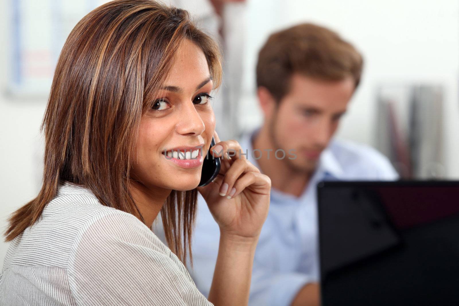 Couple at home with laptop and cellphone by phovoir