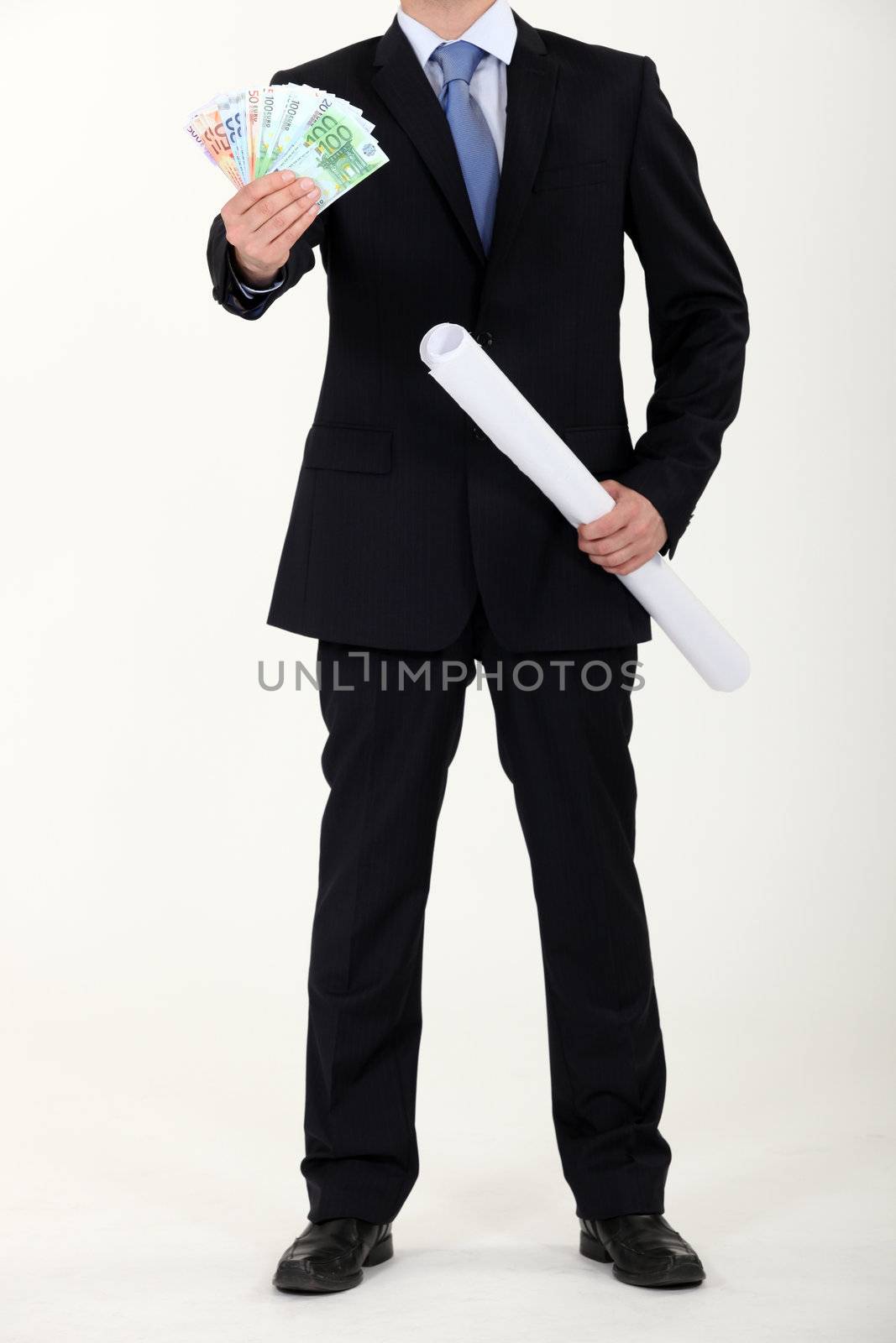 Businessman with architectural plans and a fistful of Euros by phovoir