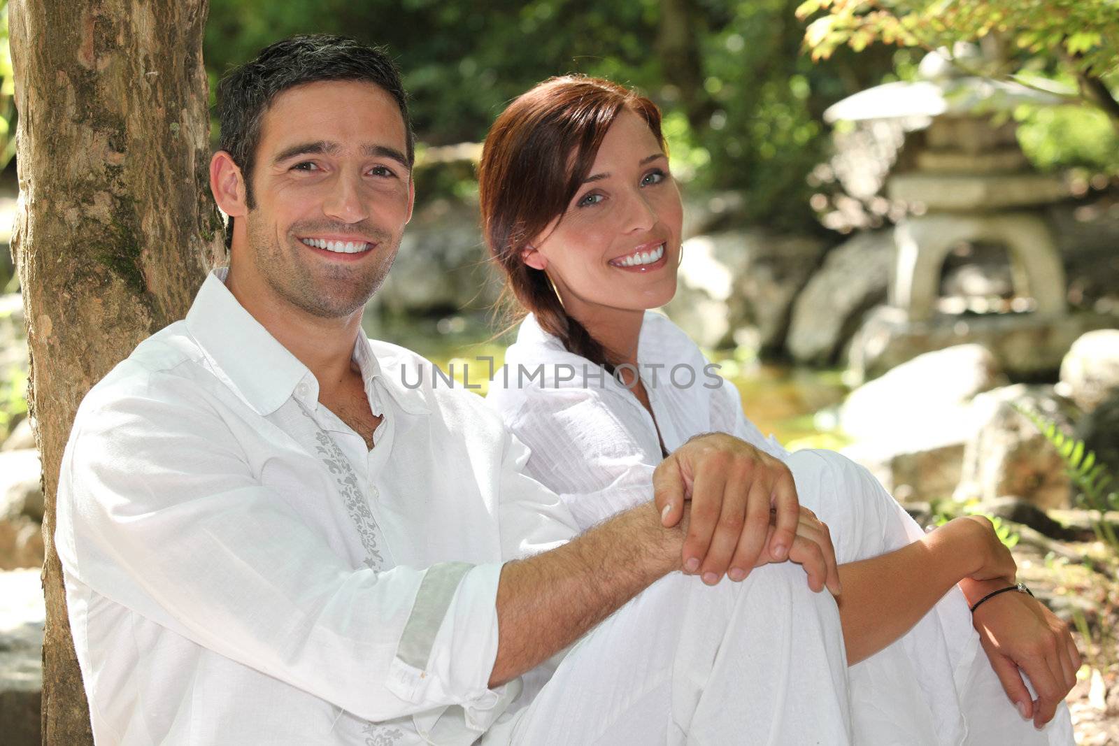 Couple in white in a oriental stone garden