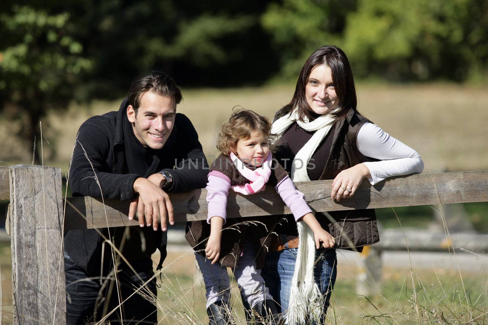 Family enjoying a walk in the countryside by phovoir