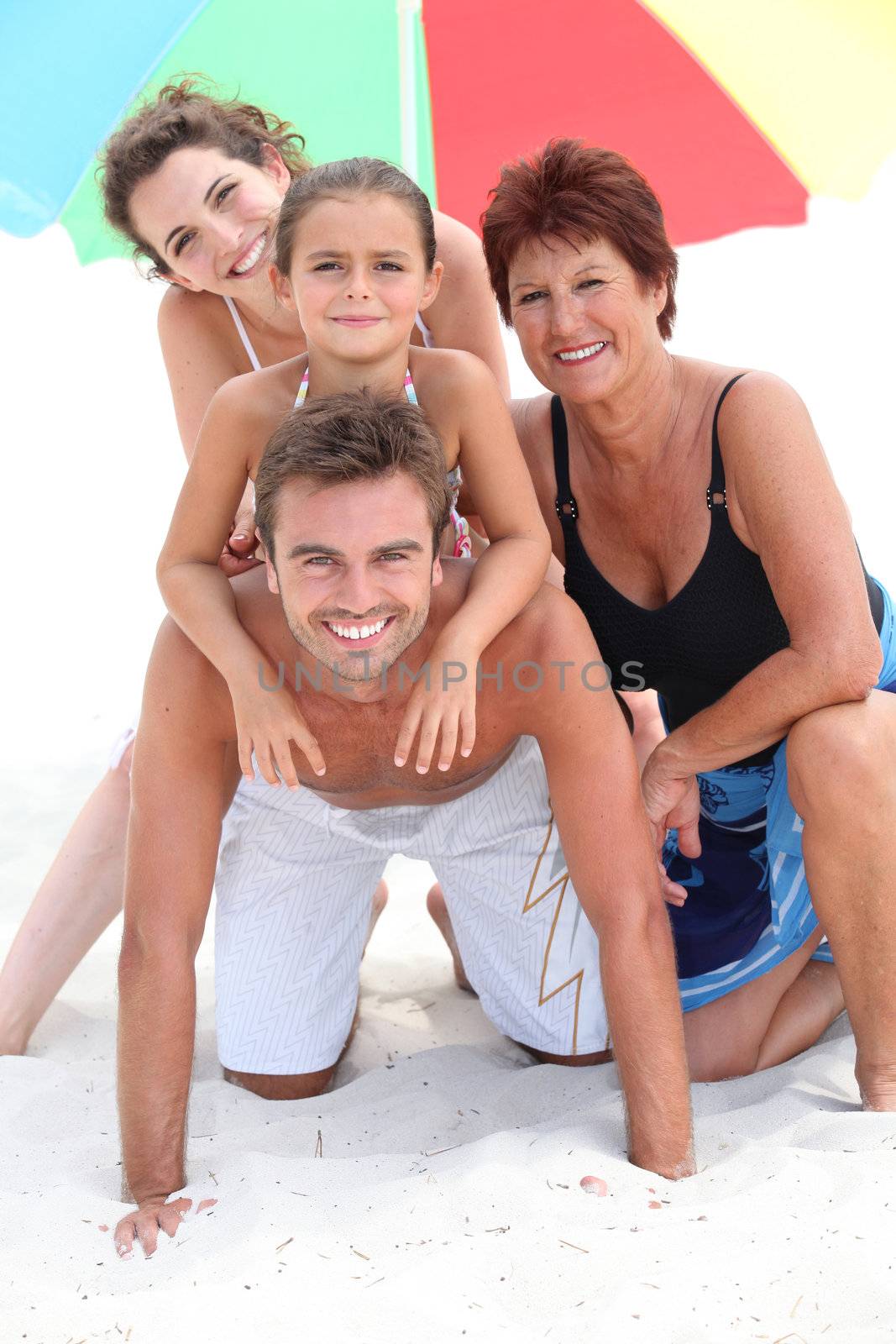 portrait of a family on the beach by phovoir