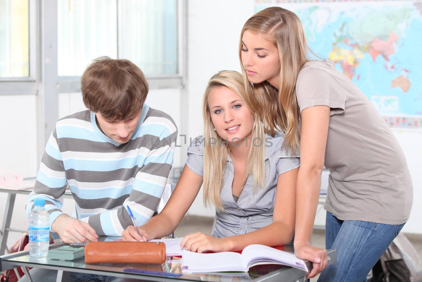 Three students in a classroom.