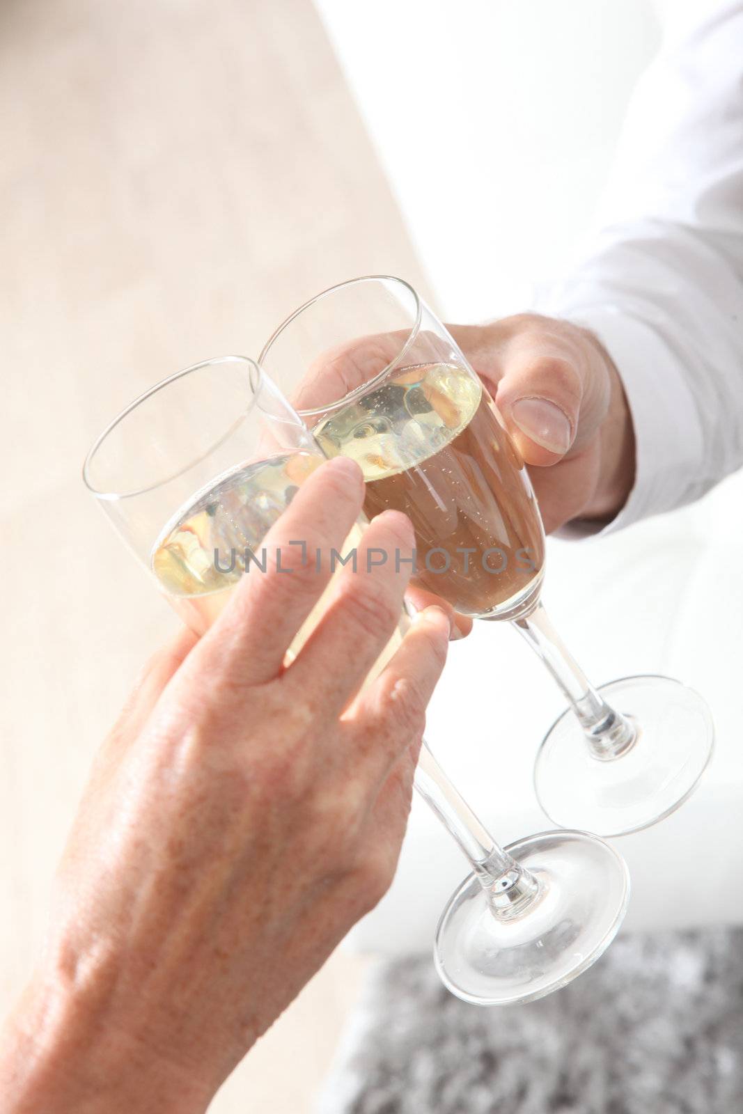 Couple with champagne flutes by phovoir