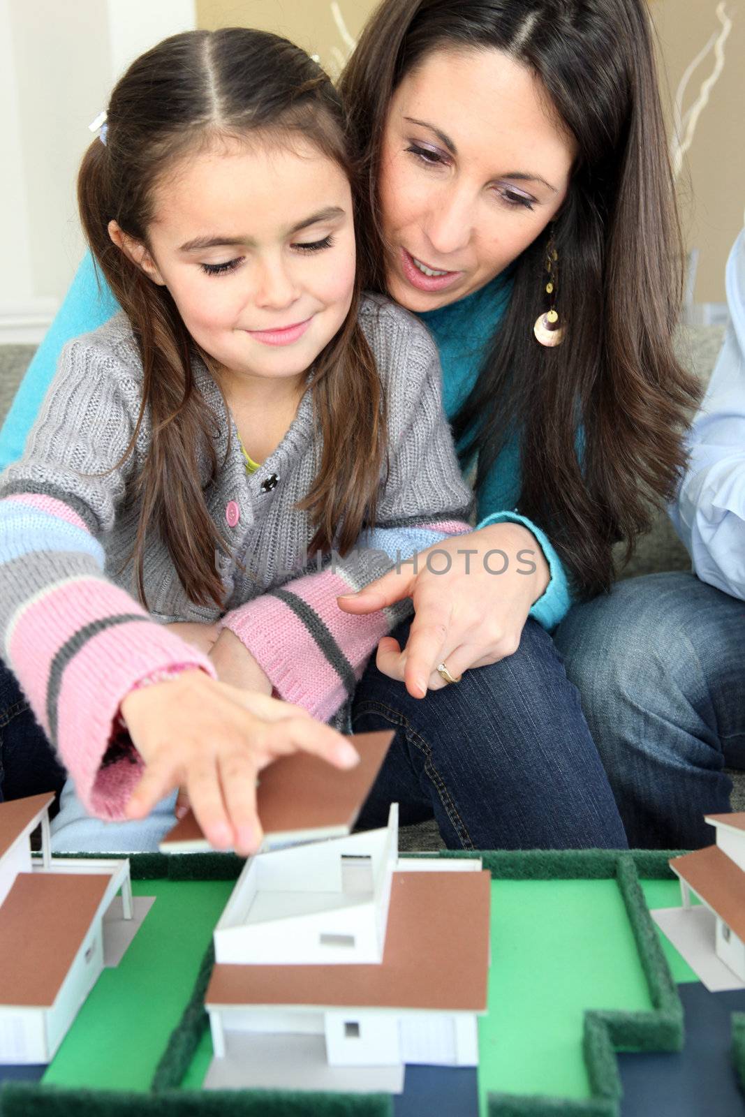 Family sat with model housing