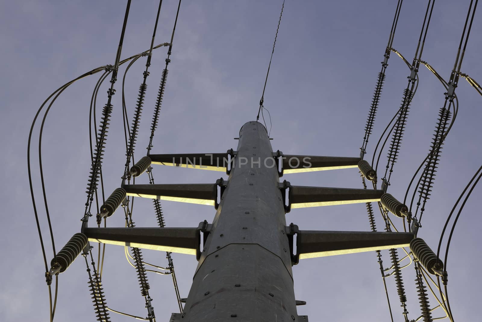 large high voltage power lines on pole viewed from directly beneath
