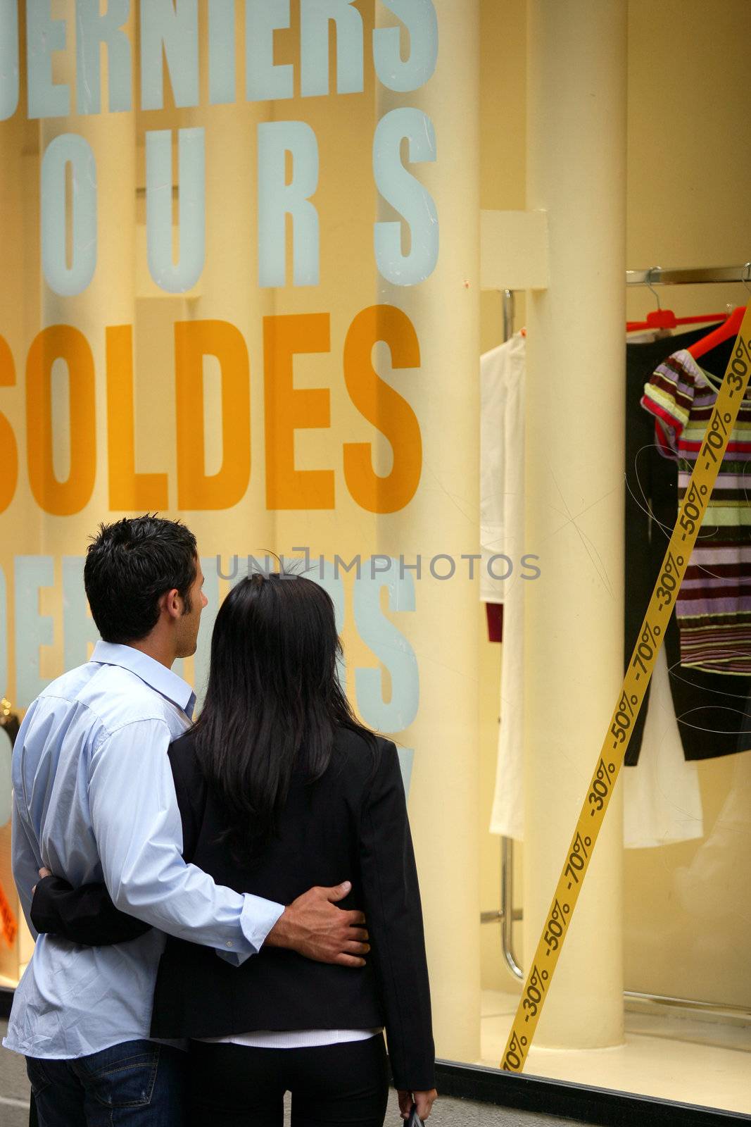 Couple window shopping during the sales by phovoir