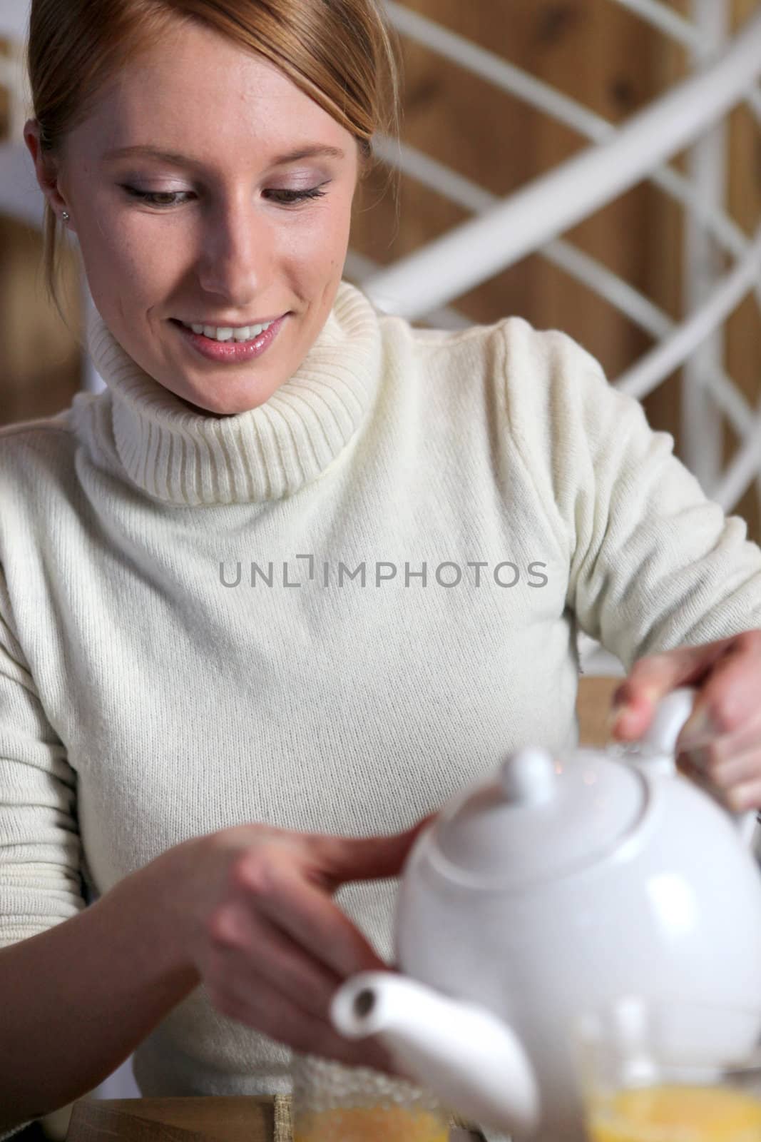 Woman pouring tea by phovoir