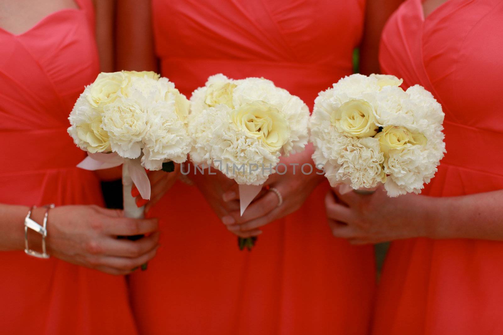 Close-up of bridesmaids holding their wedding bouquets.