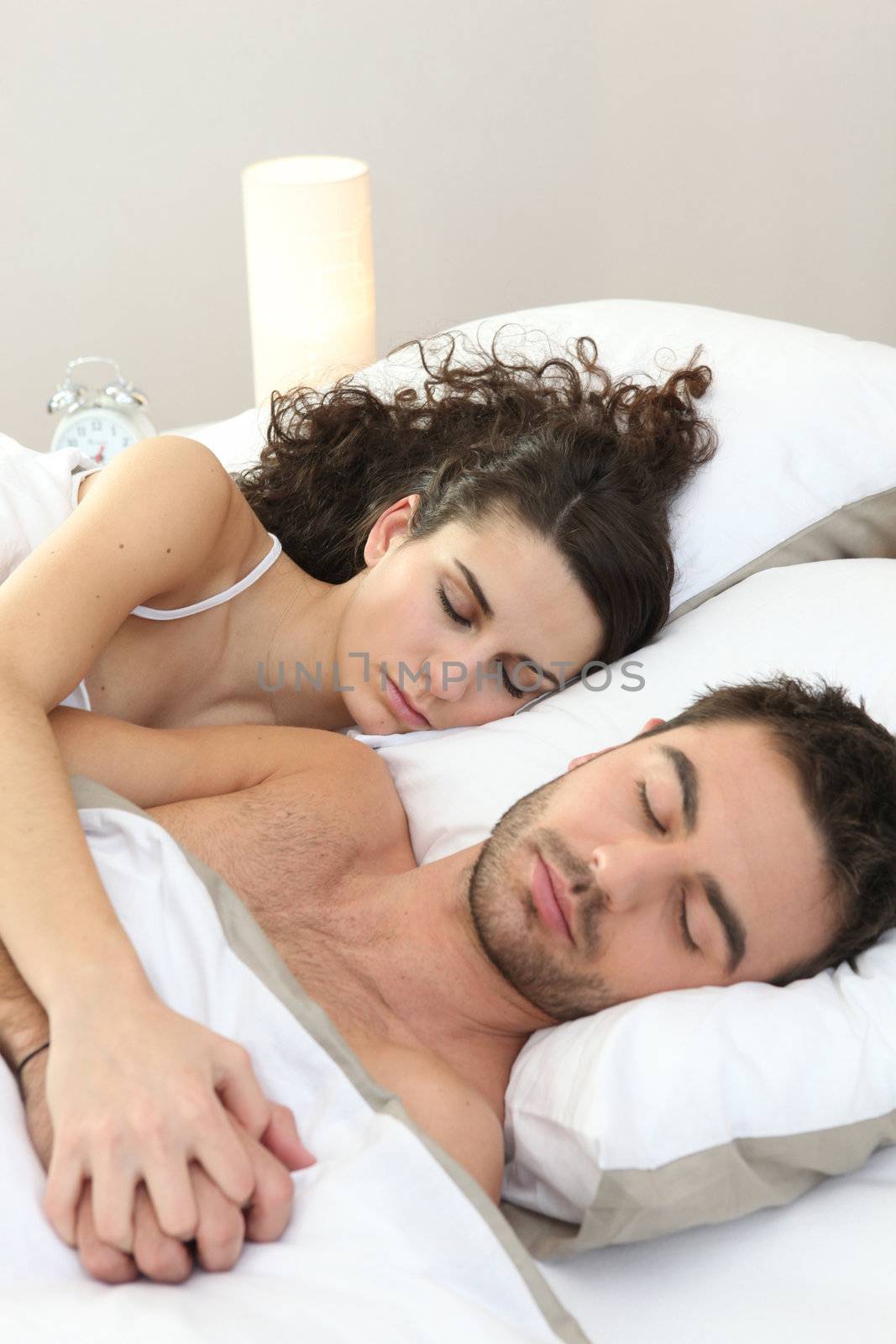 Couple sleeping in bed by phovoir