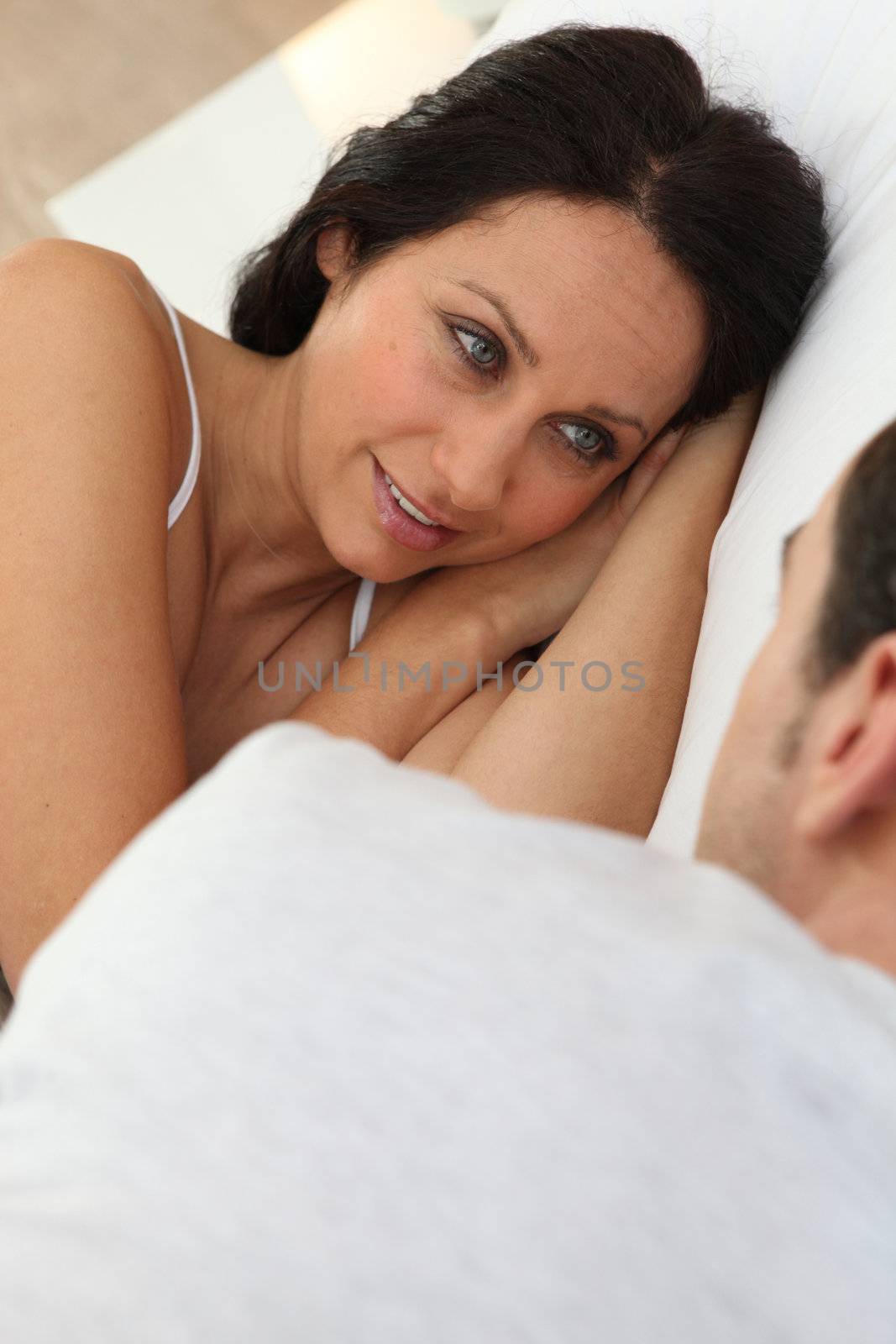 Couple talking in bed
