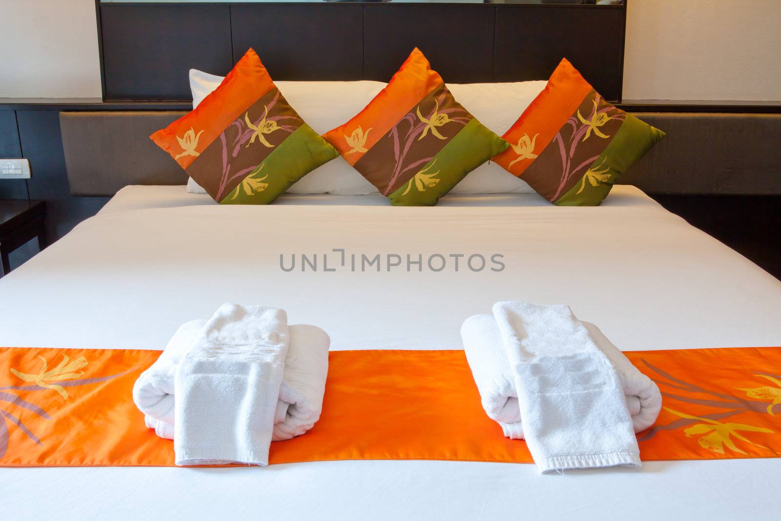 Hotel room in a tropical resort with bed and wooden flooring