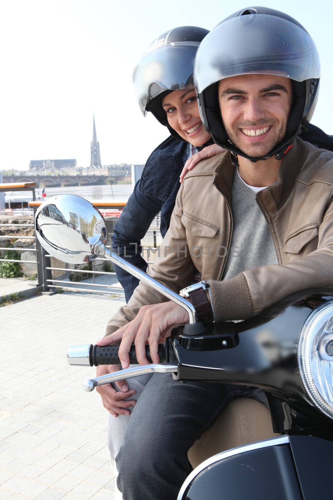 Young couple having a motorbike ride by phovoir