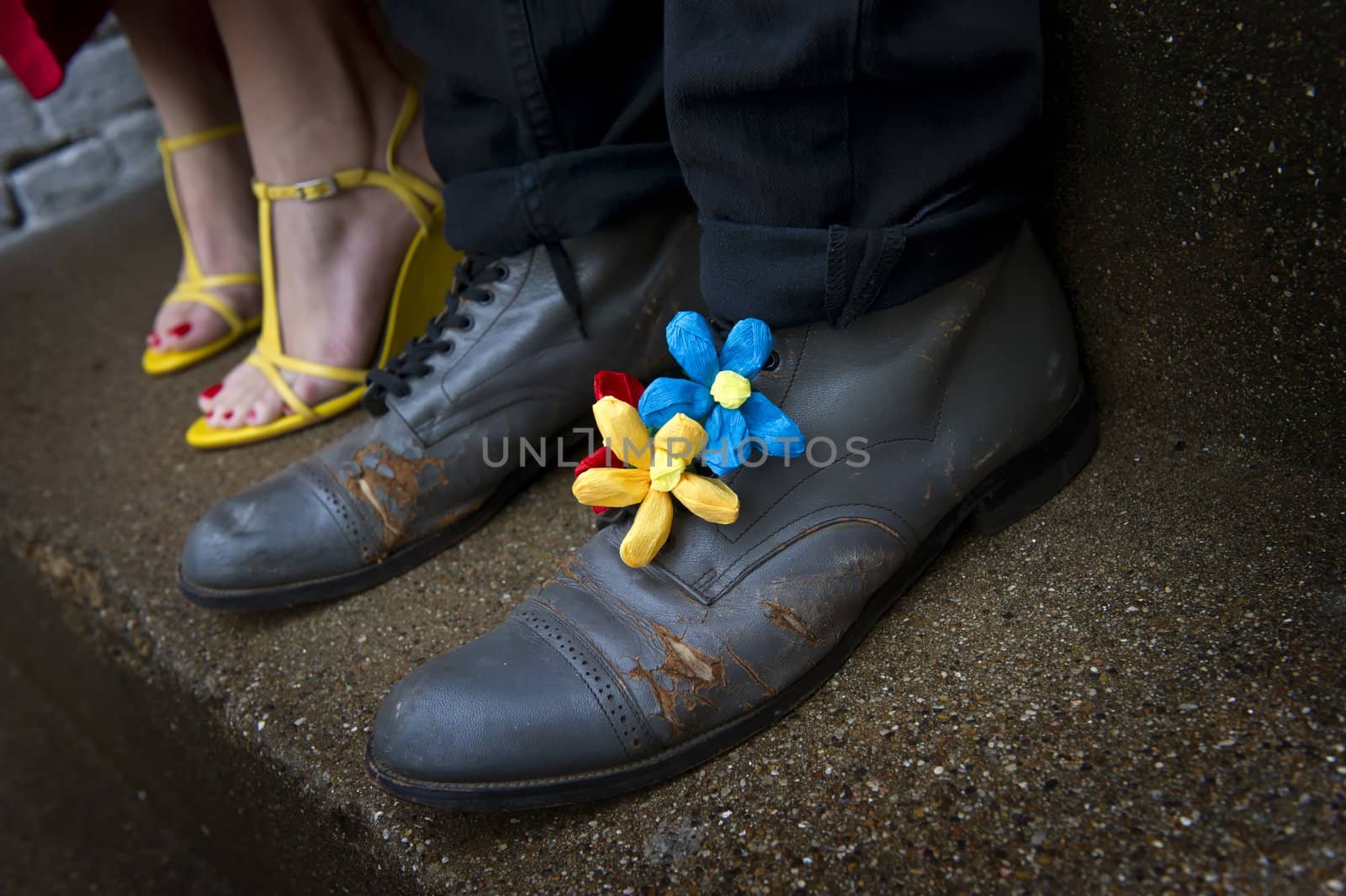 Image of a pair of Grungy shoes with flower decorations and a second pair of yellow wedges in background