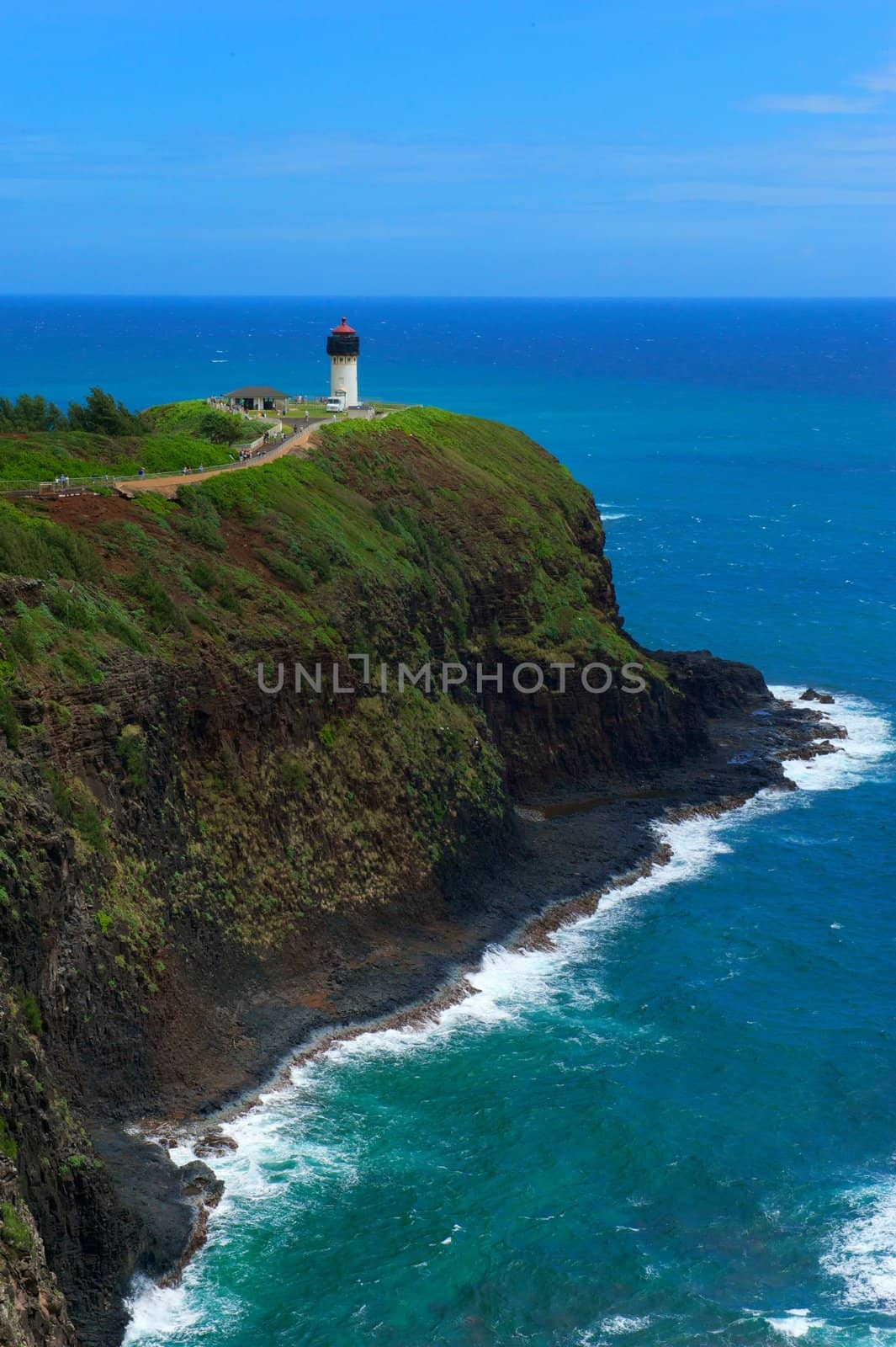 A lighthouse atop a rock formation on the northern shore of island of Kauai, Hawaii, USA