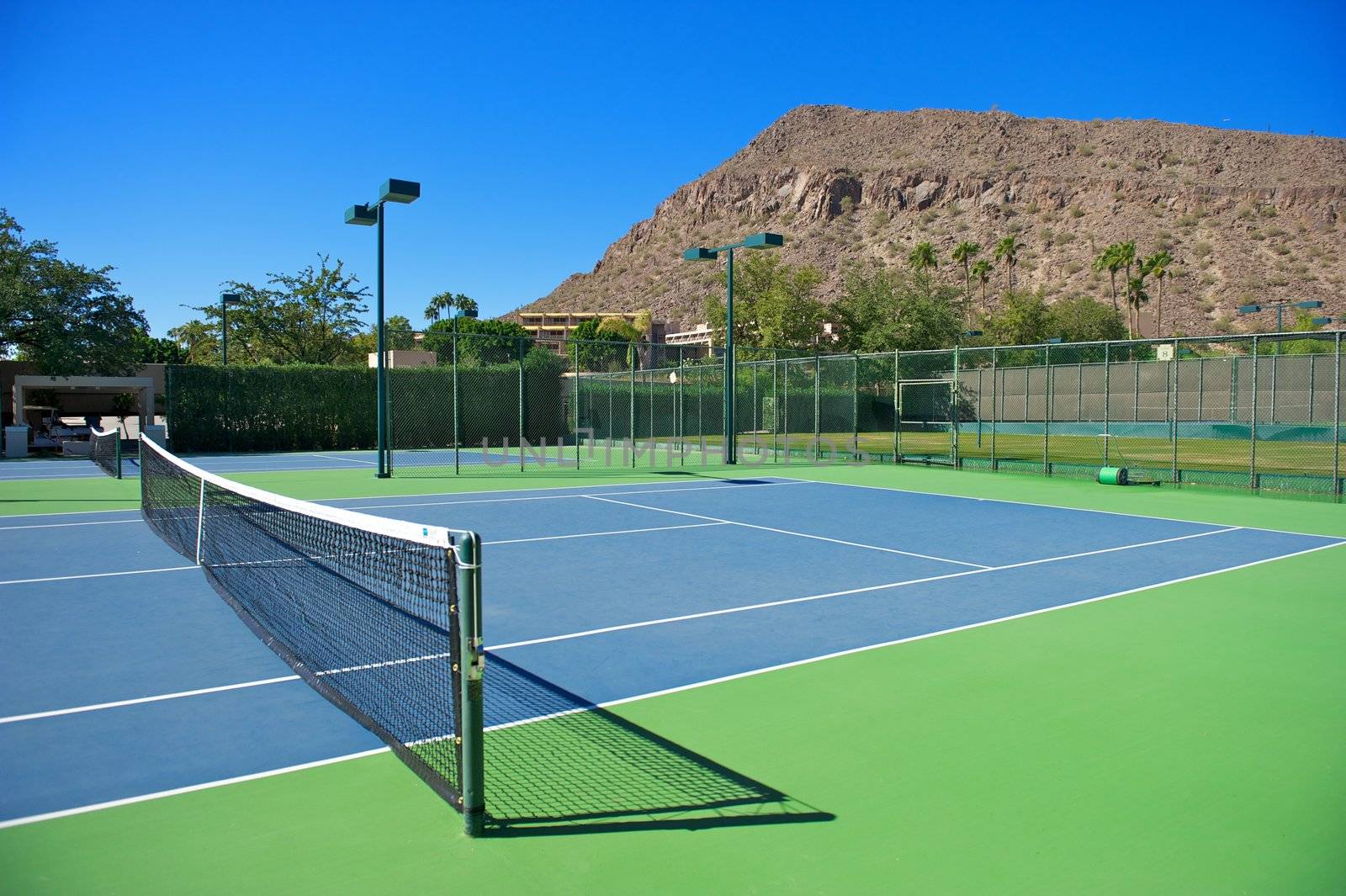 Horizontal shot of a blue surfaced tennis court