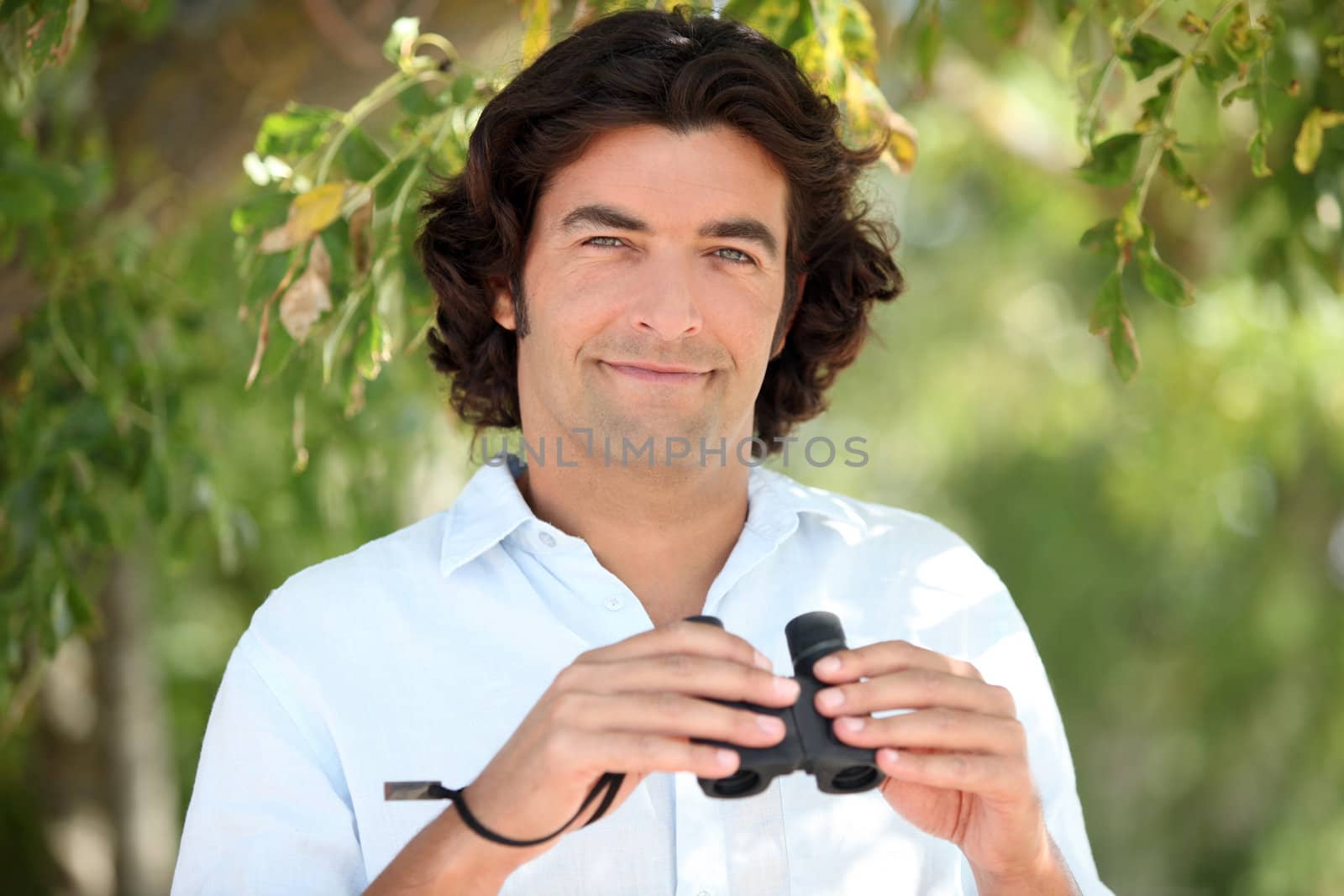 Man holding a pair of binoculars