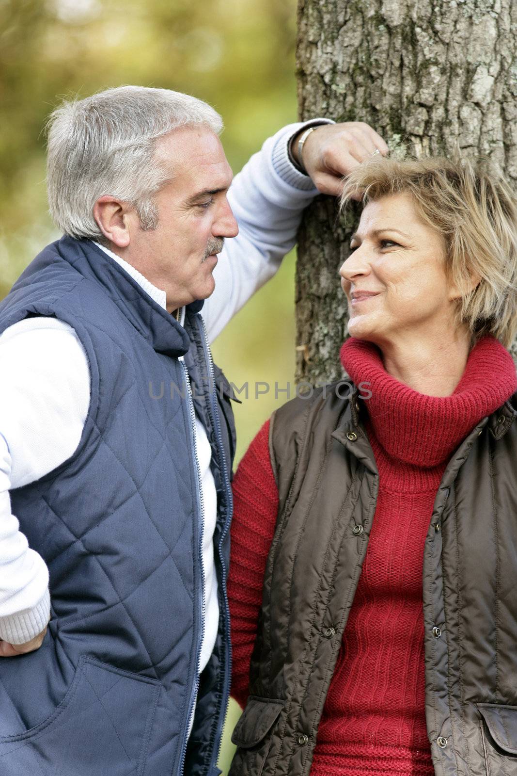 Loving couple standing by a tree