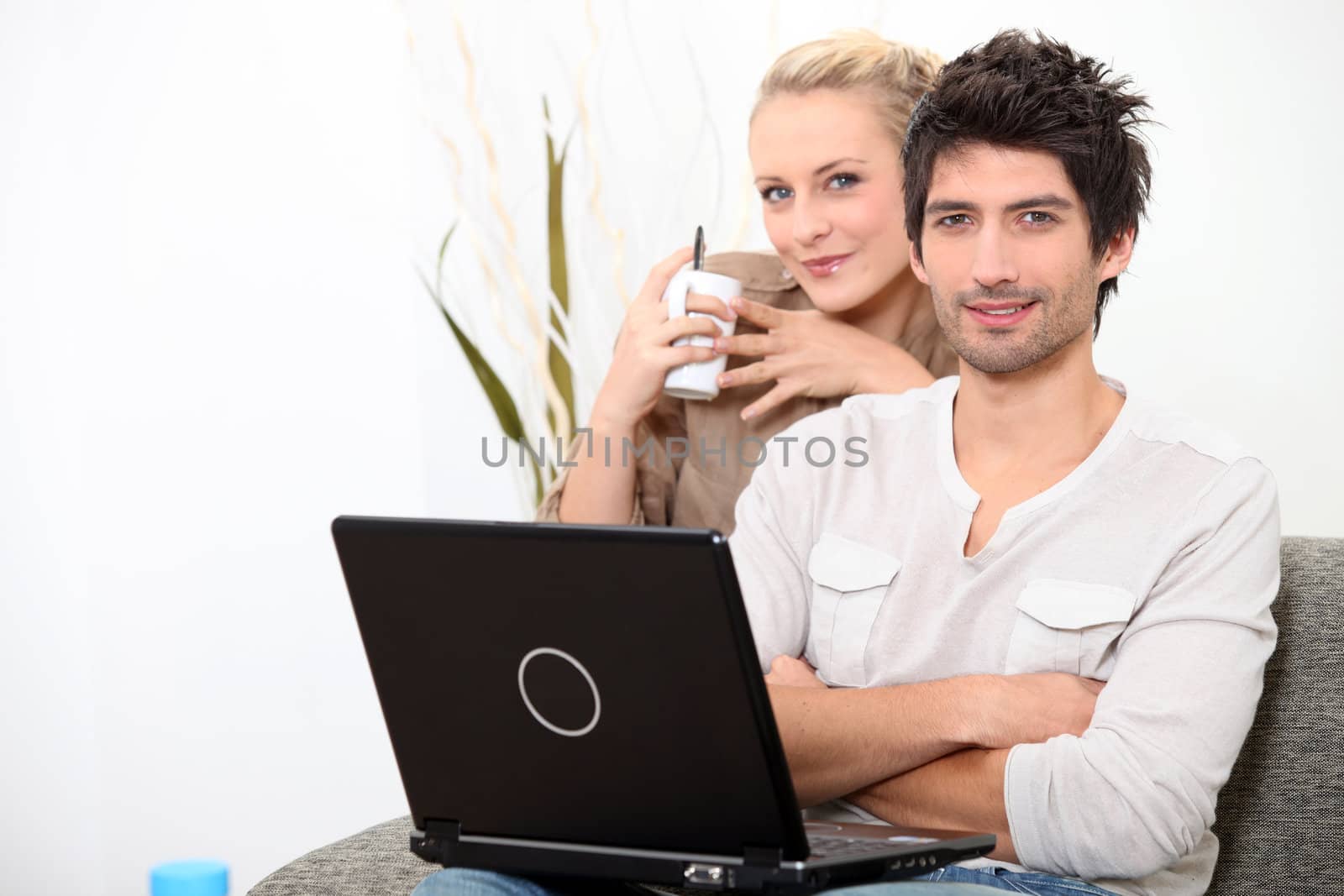 Couple relaxing at home on a Sunday morning by phovoir