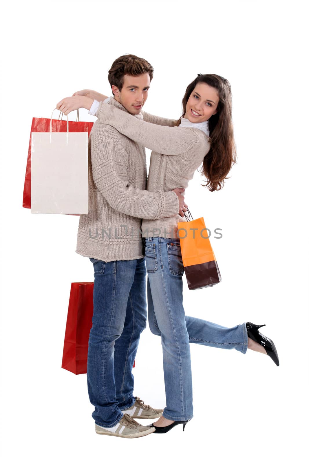 Couple with shopping bags hugging