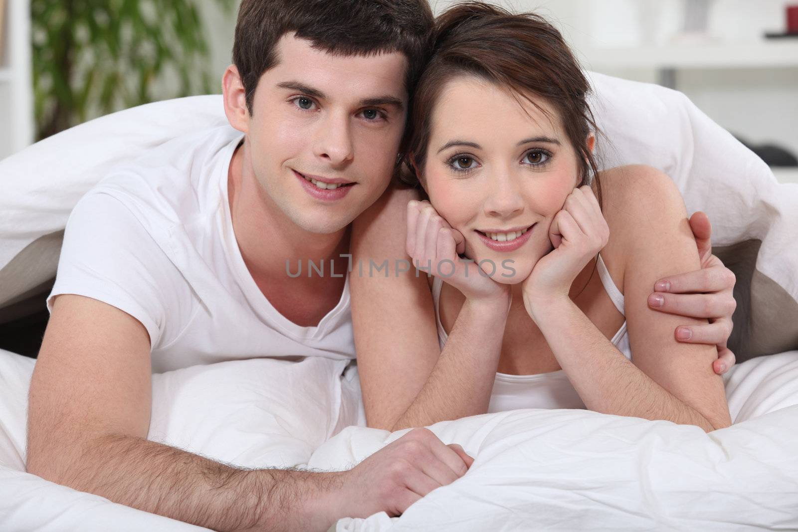 young couple embracing in bed