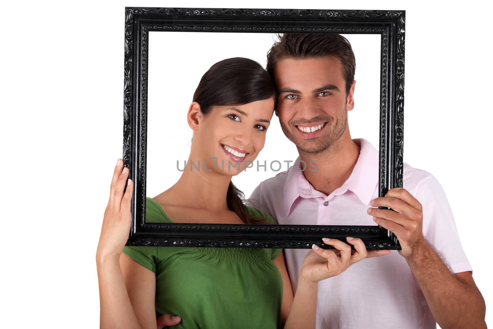 Couple stood with empty picture frame by phovoir