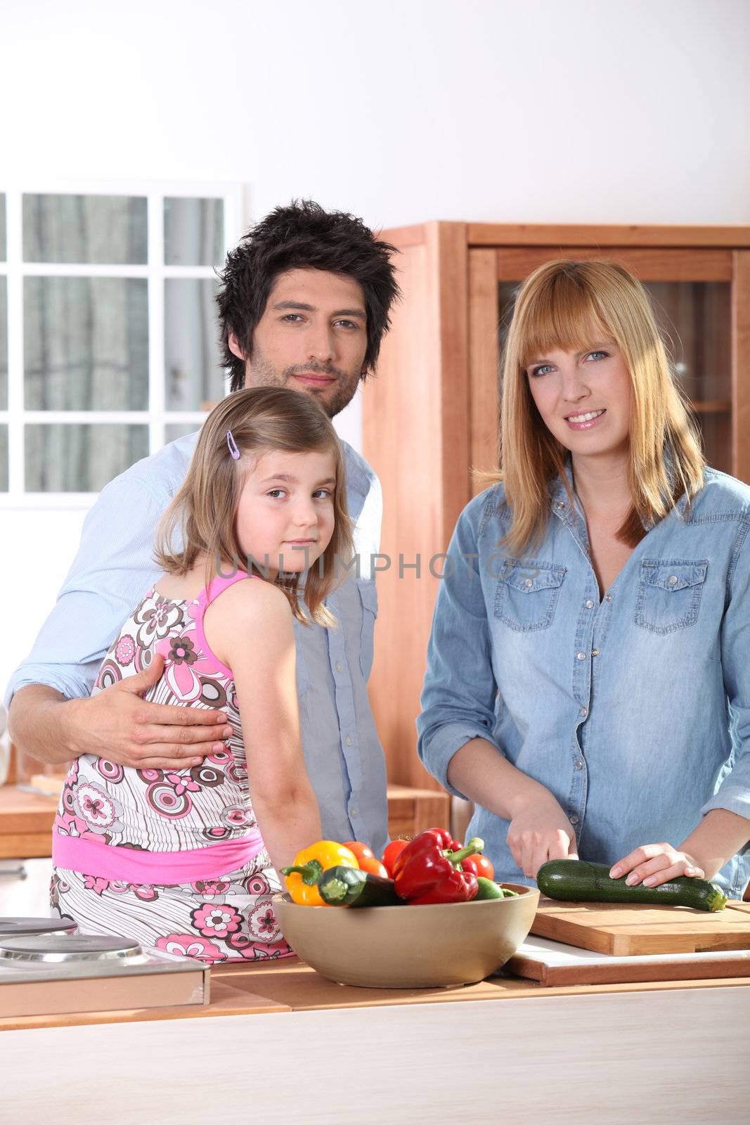 Family in kitchen by phovoir