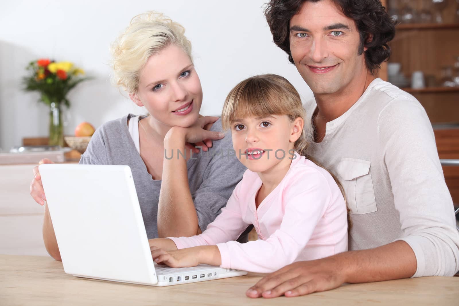 Family using a laptop computer by phovoir