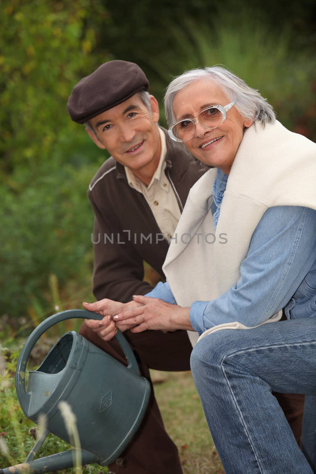 elderly couple gardening by phovoir