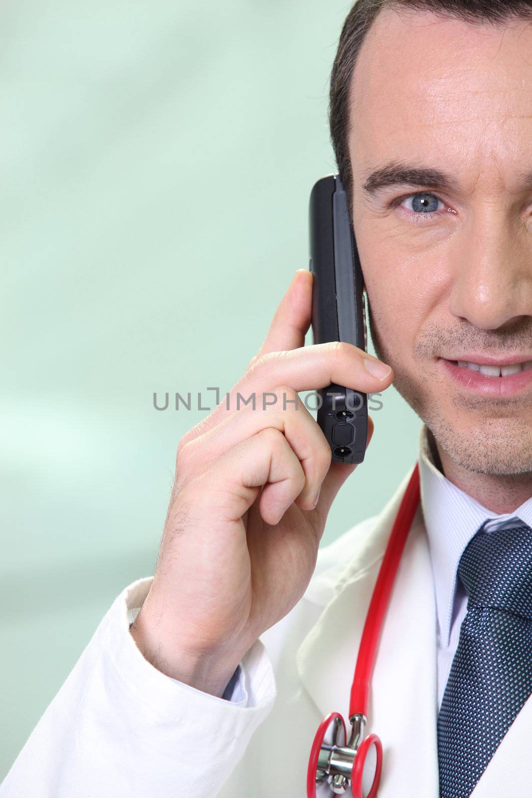 Male doctor making telephone call by phovoir