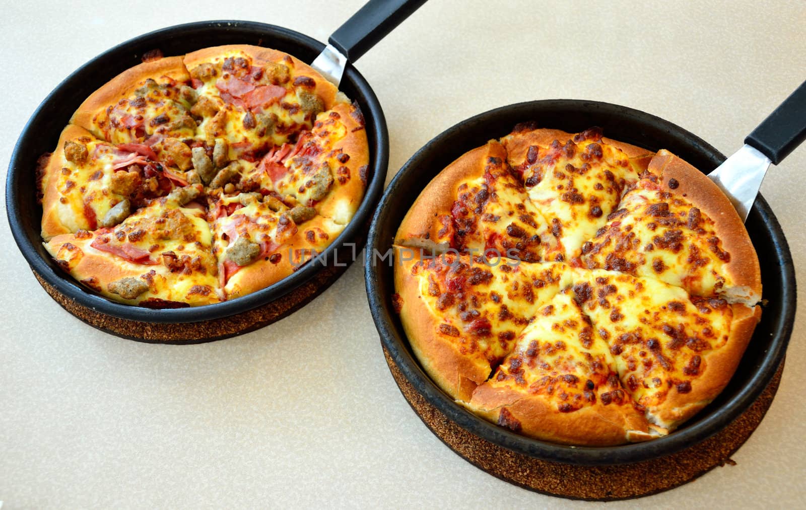 Pizza in the hot pan, Meat pizza and cheese pizza.