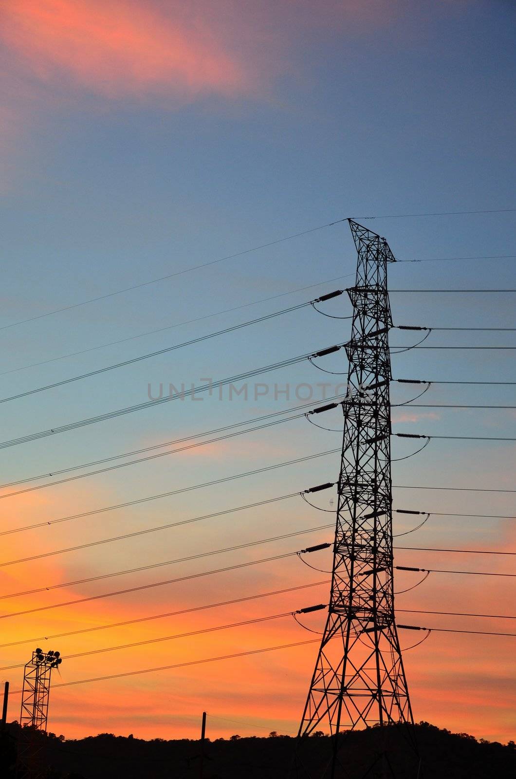 Eletric power post with sunset sky background.