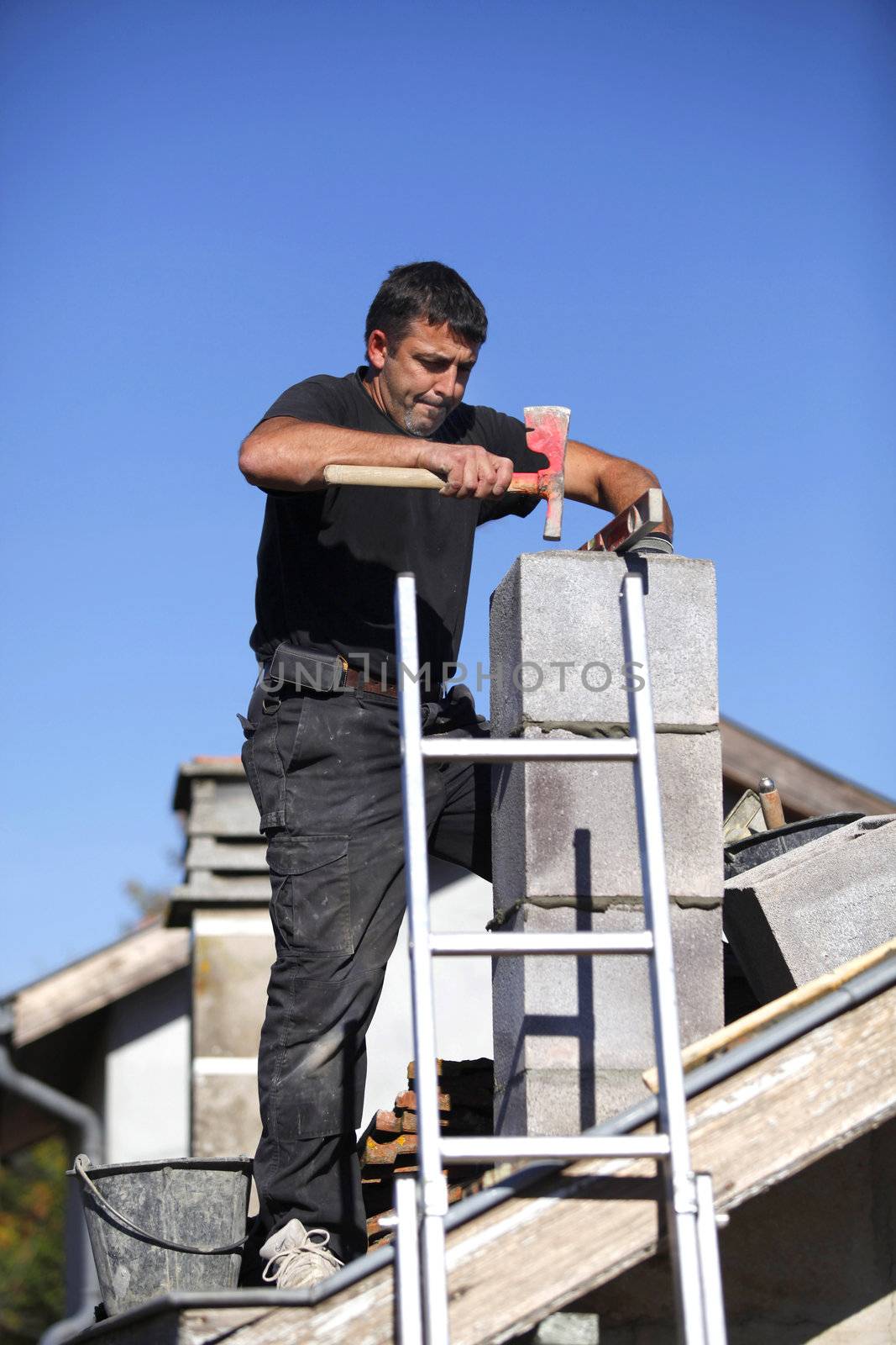 Builder constructing a chimney by phovoir