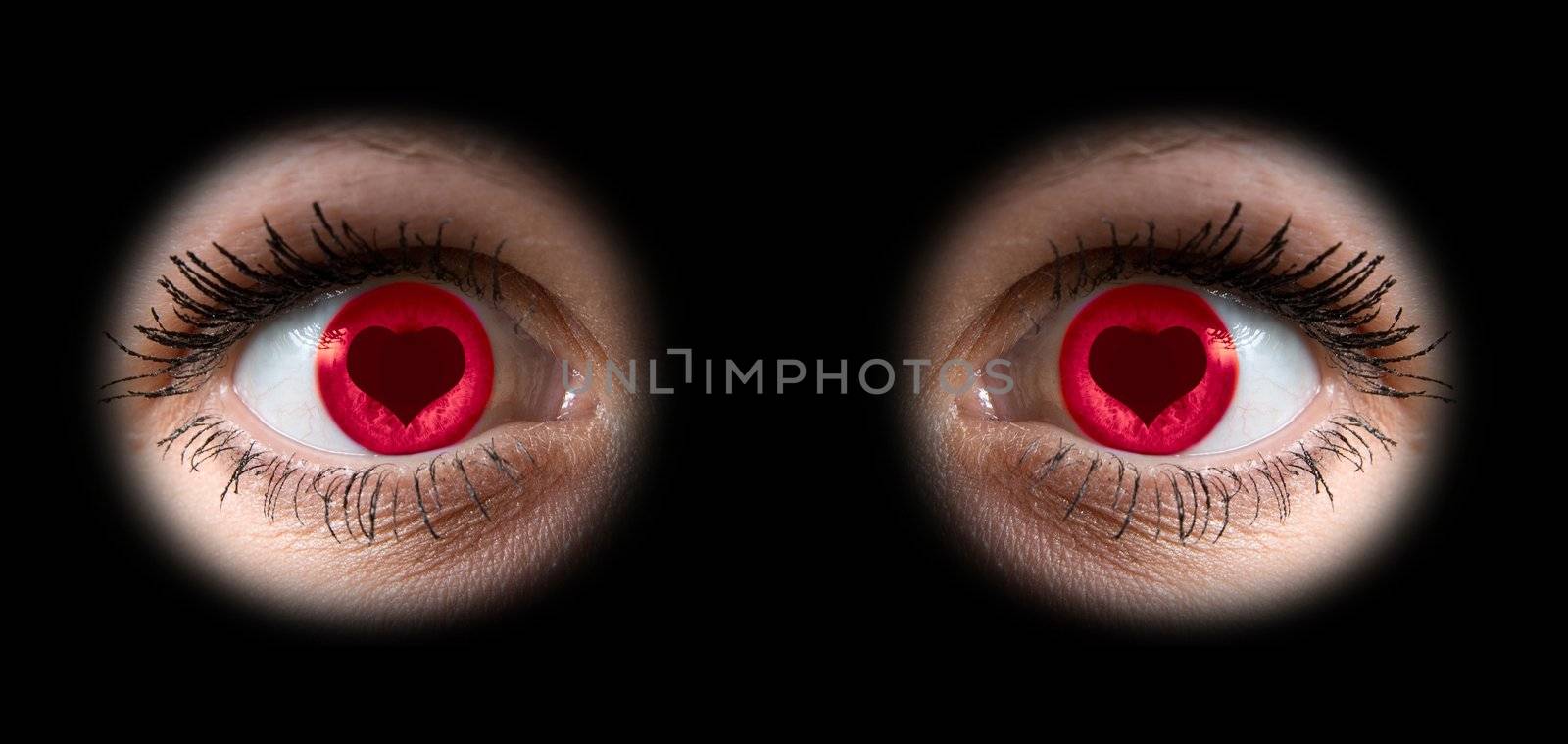 Close up of a woman  eyes with love at pupil on black