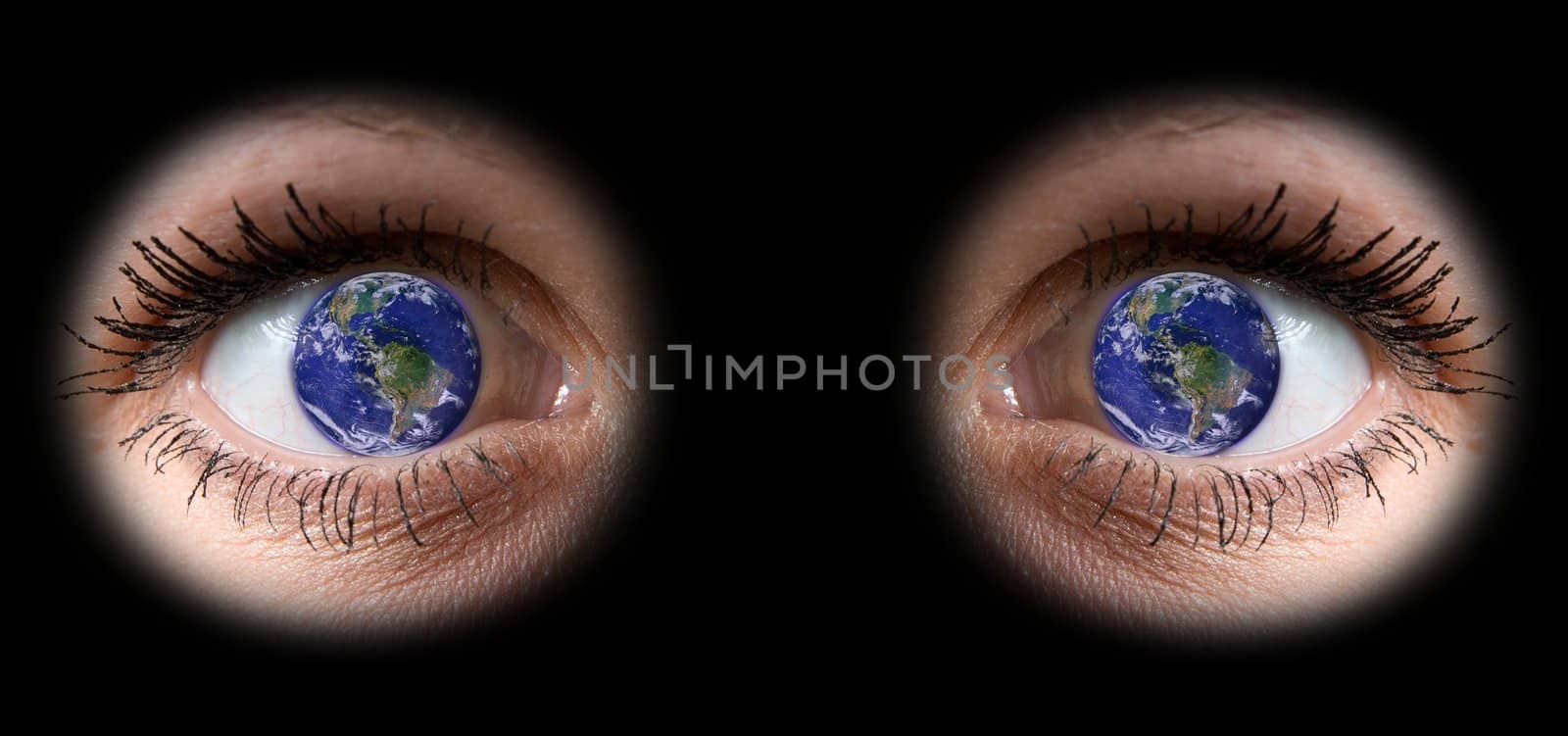 close up of a girl eyes with planet Earth into the pupil

