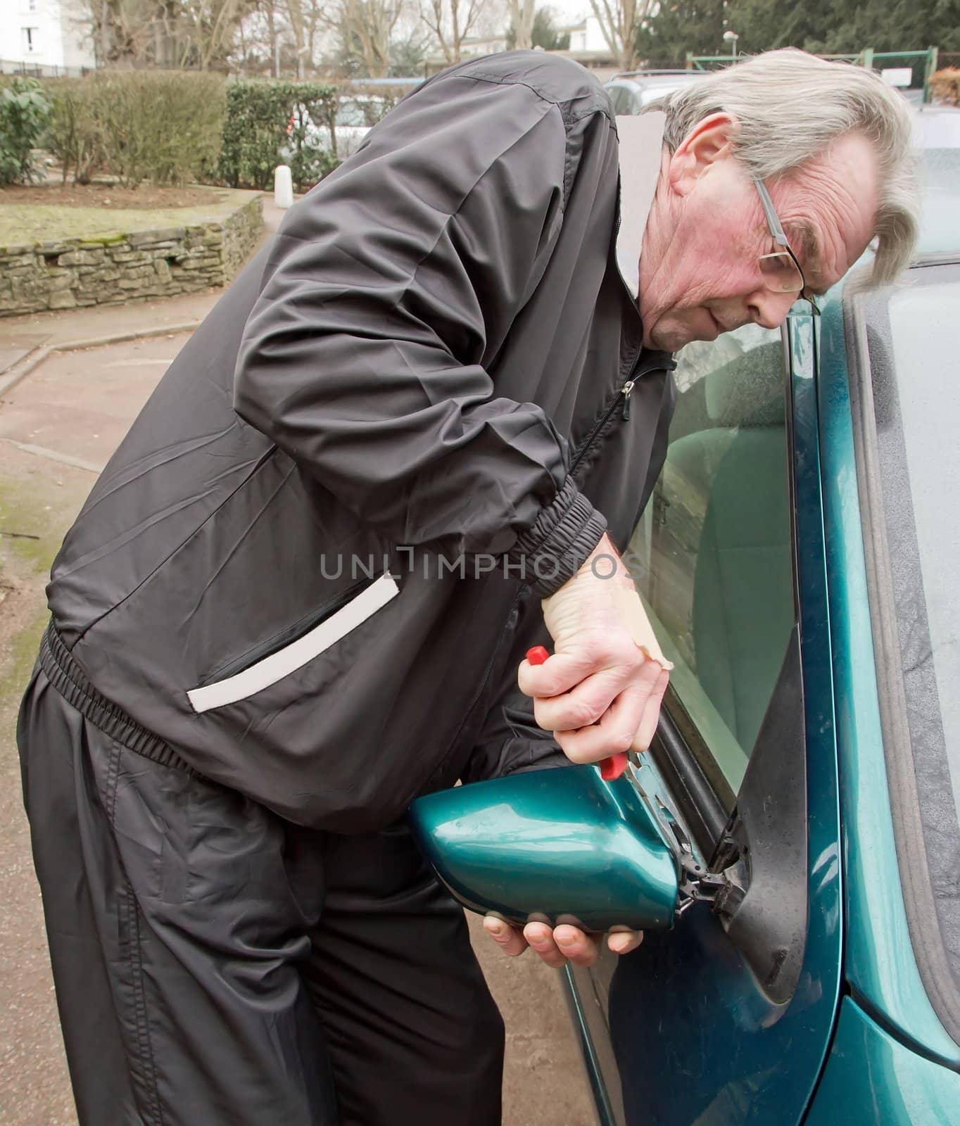 repairing a broken car mirror after an act of vandalism in the city  France