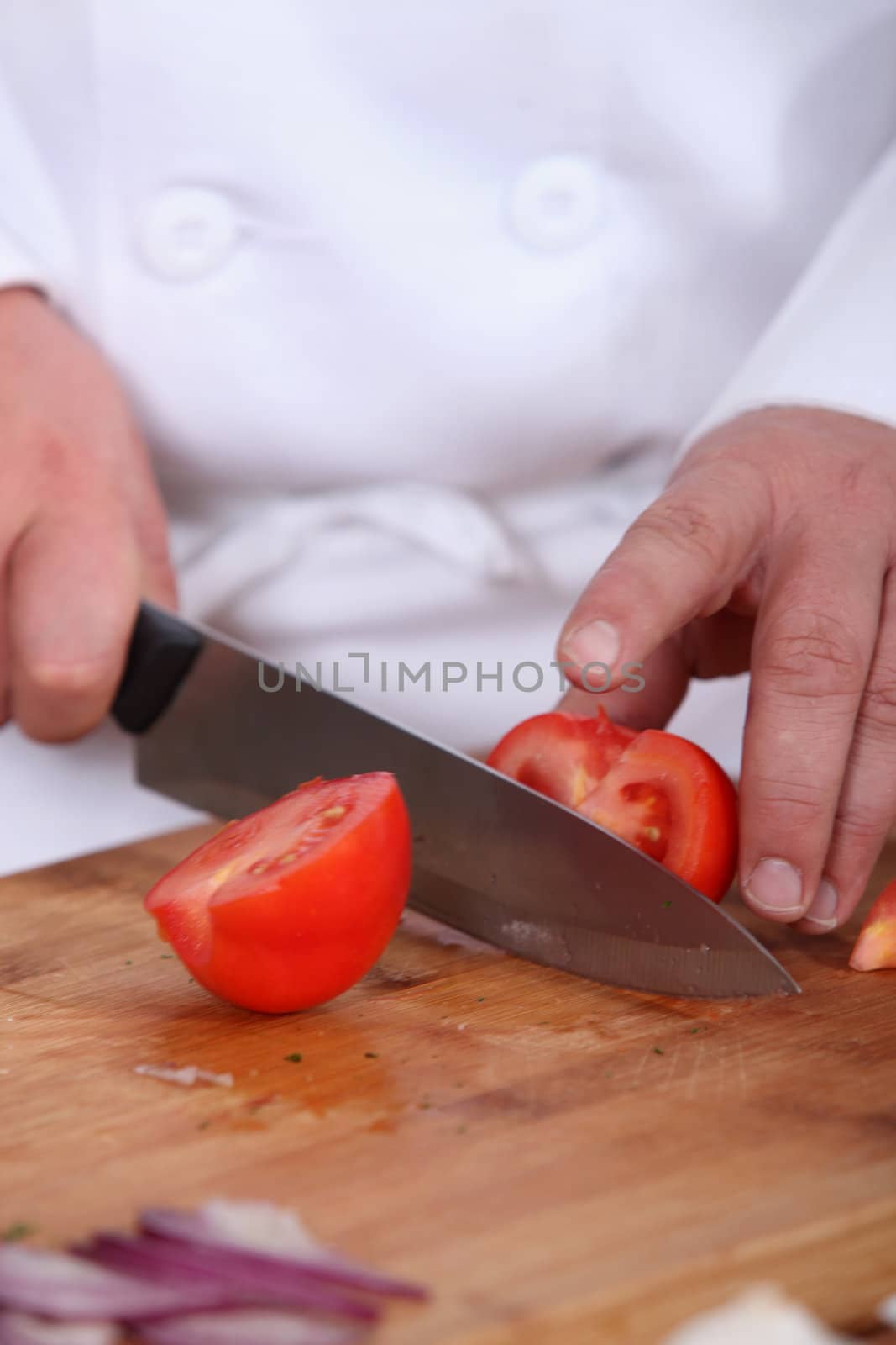 Chef chopping tomato by phovoir