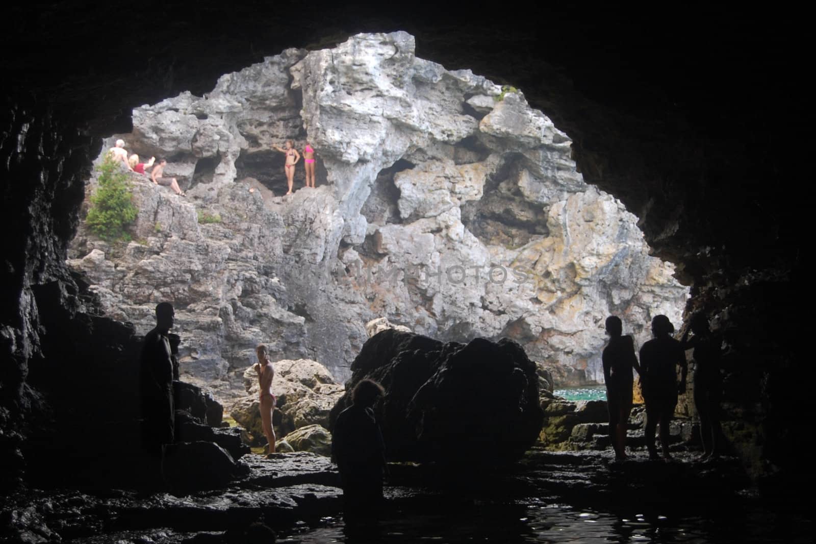 Swimmers at the Grotto, a cave carved from Lake Huron's shores by wave action over the centuries.