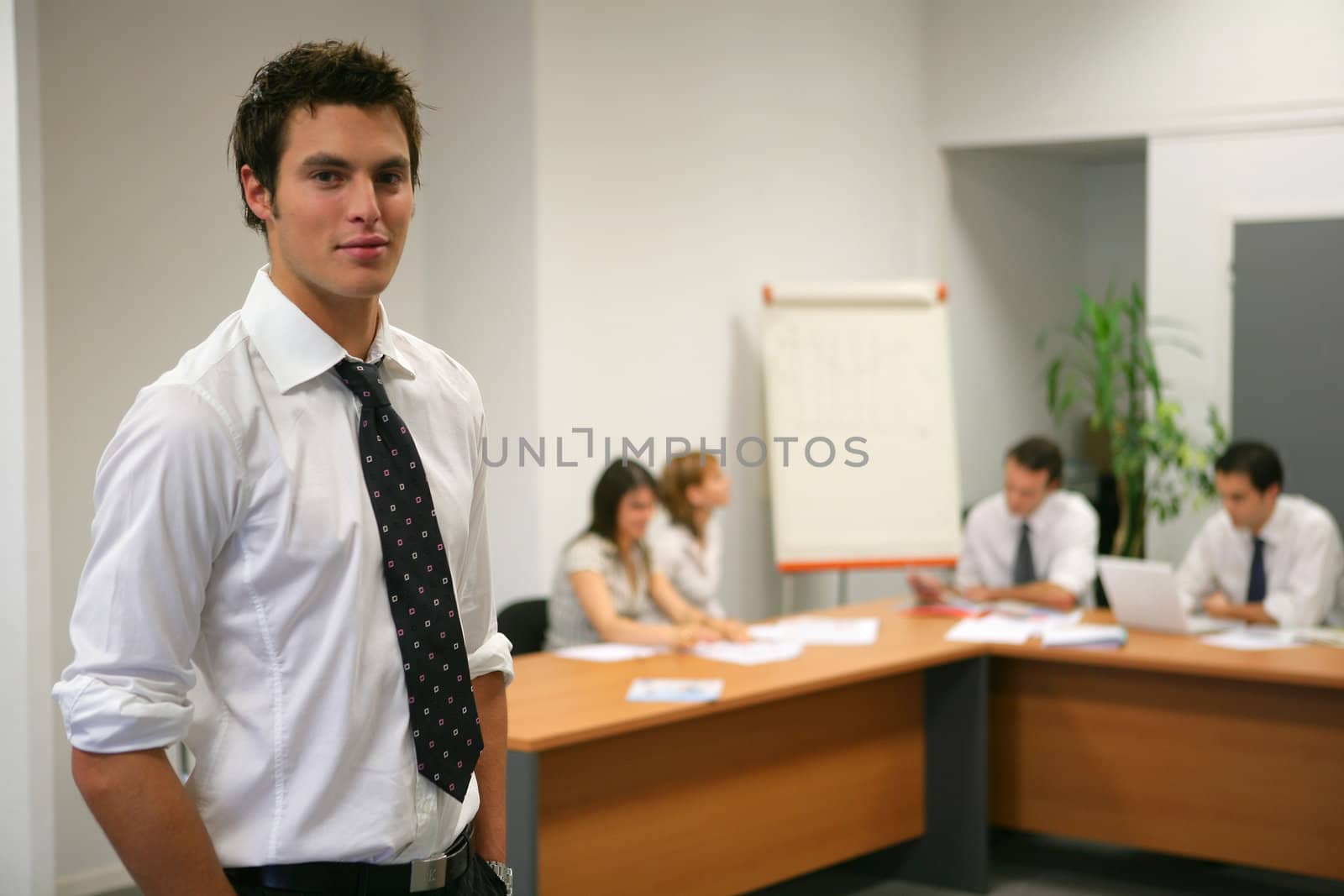 Young businessman about to give presentation to executives by phovoir