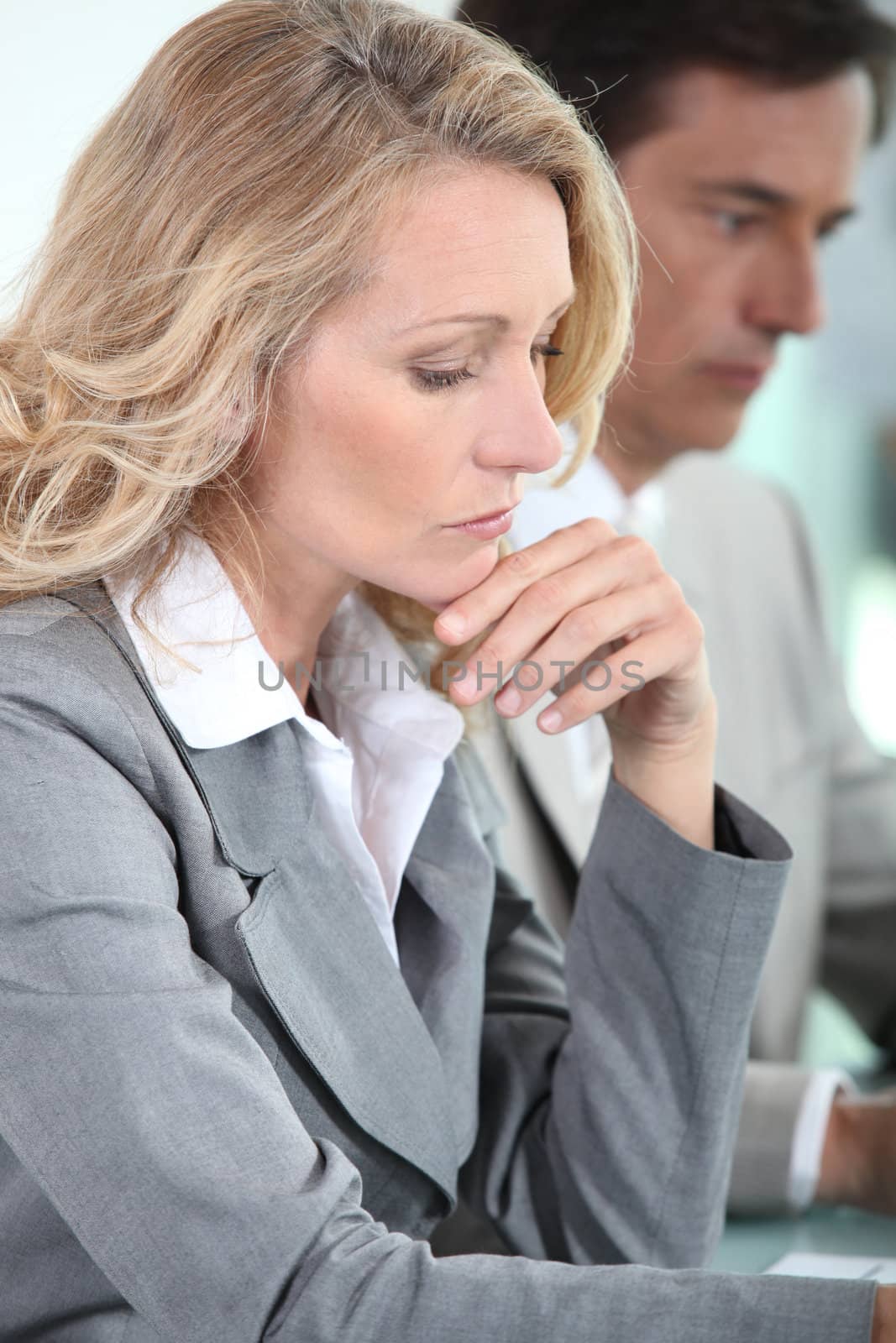 Woman thinking in meeting by phovoir