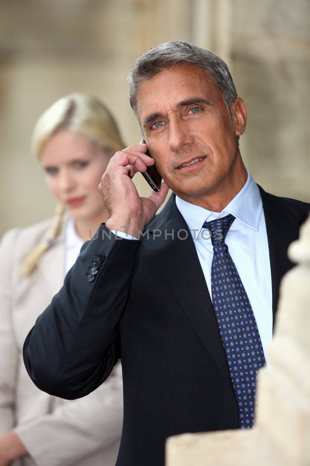 Businessman talking on cellphone outdoors