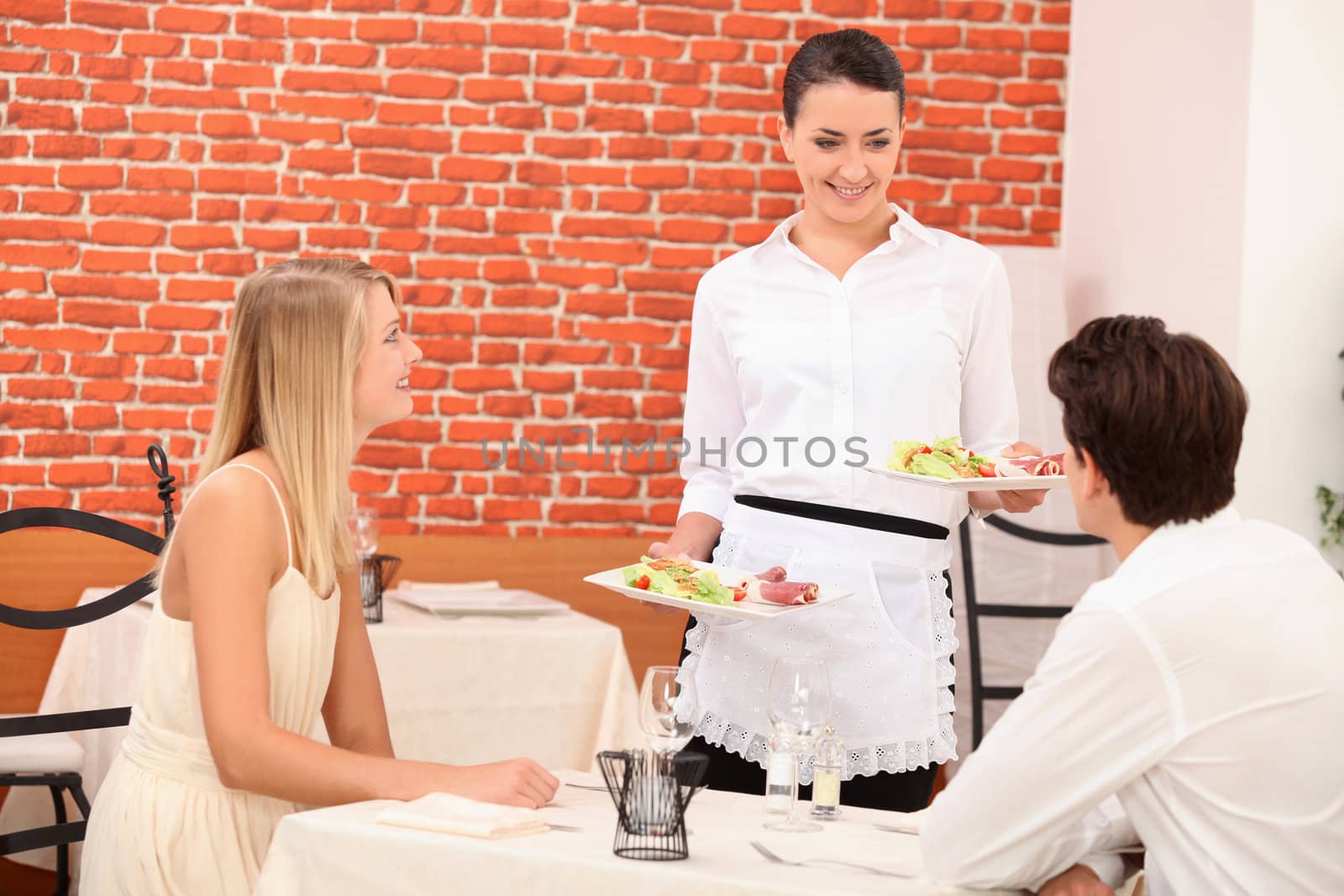 Waitress serving couple