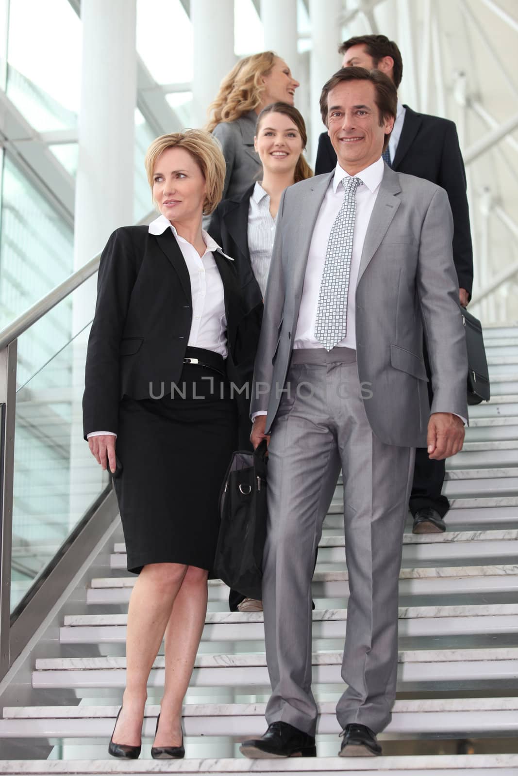 Business people walking down steps by phovoir