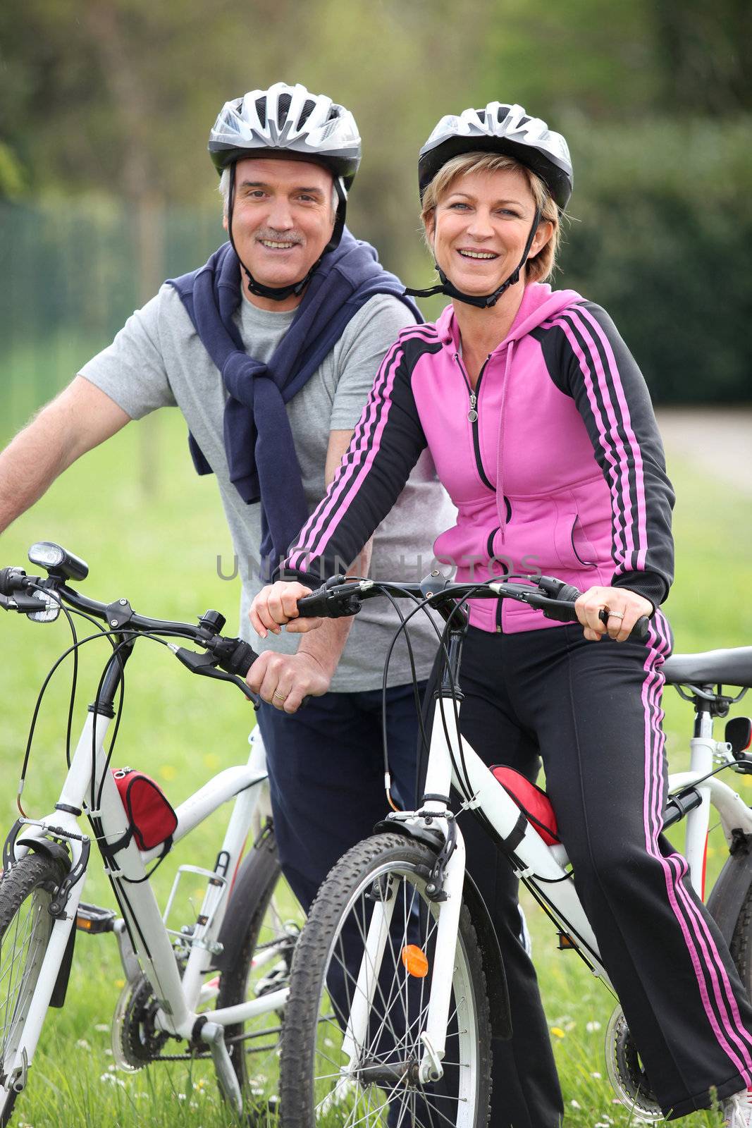 Couple having a bike ride by phovoir