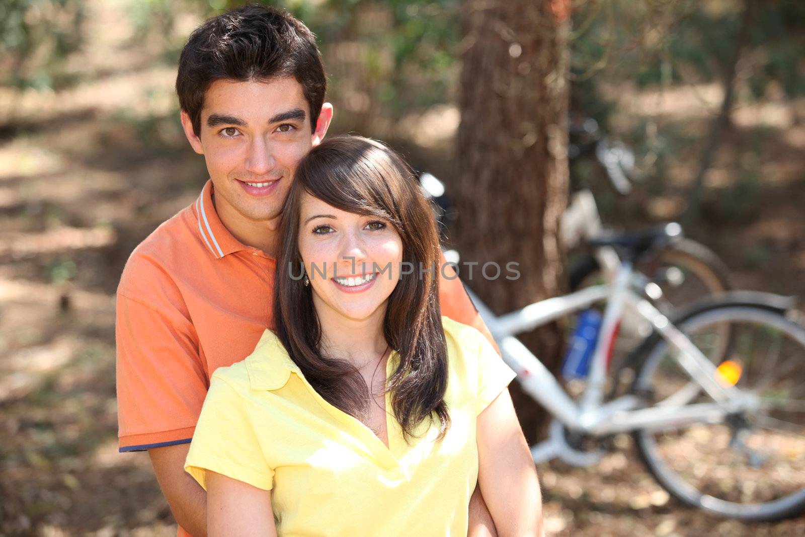 Young couple outdoors with bicycles by phovoir