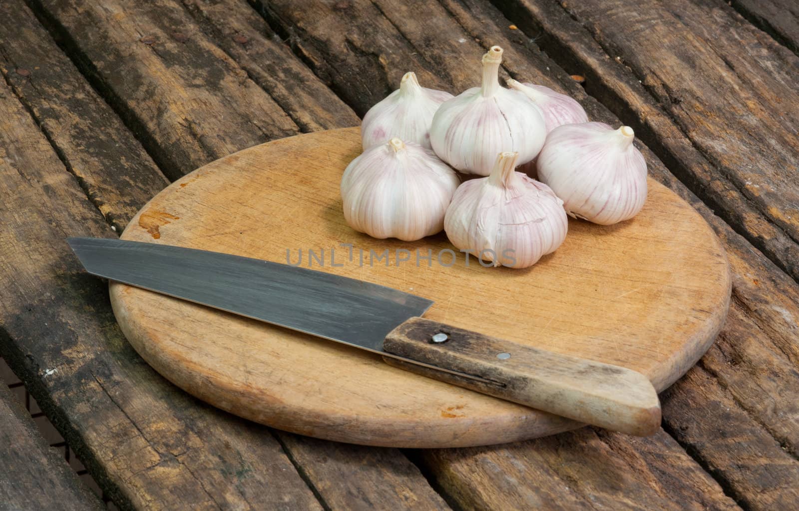 Garlic and Knife on wood background