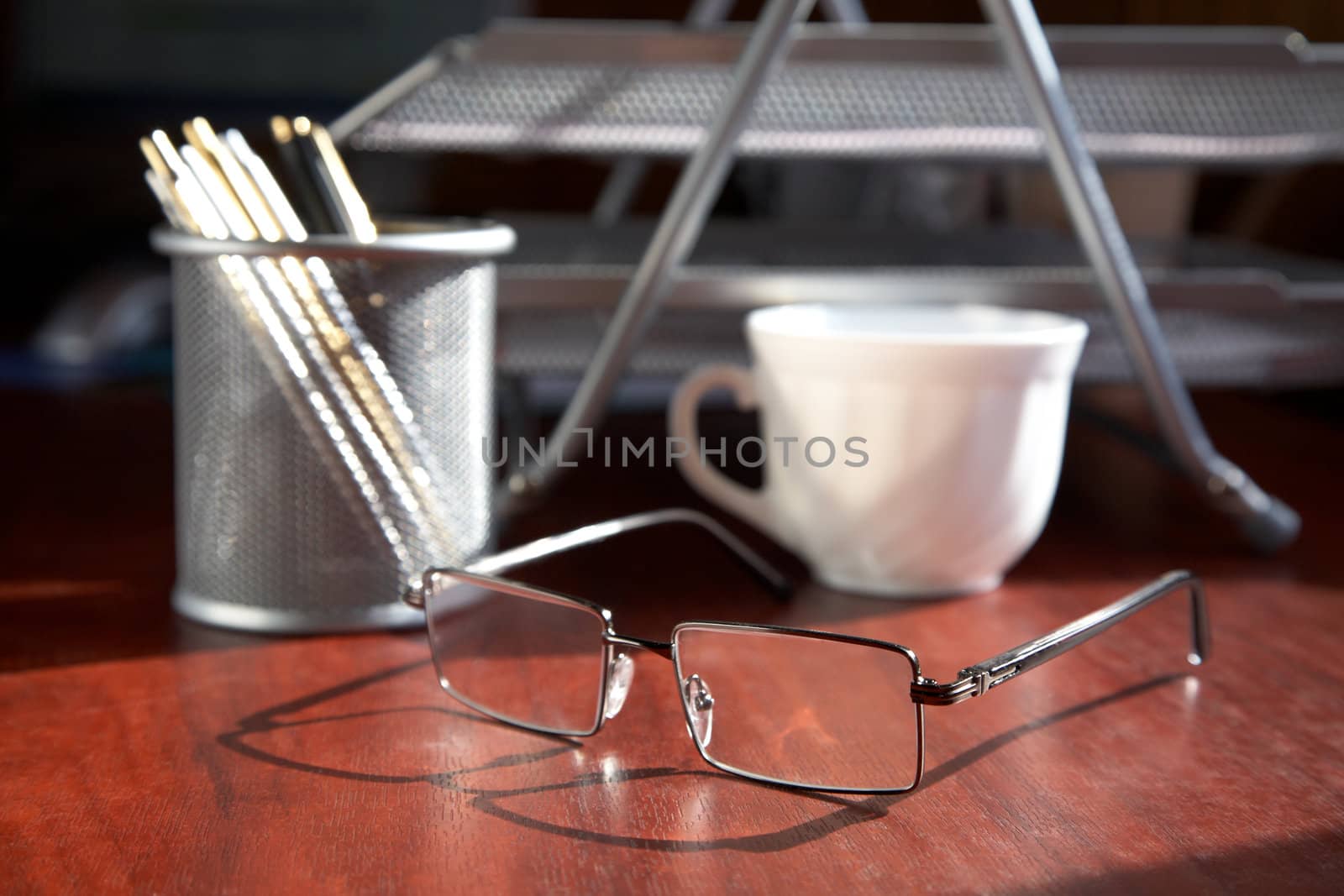Business still-life with points a cup and office accessories