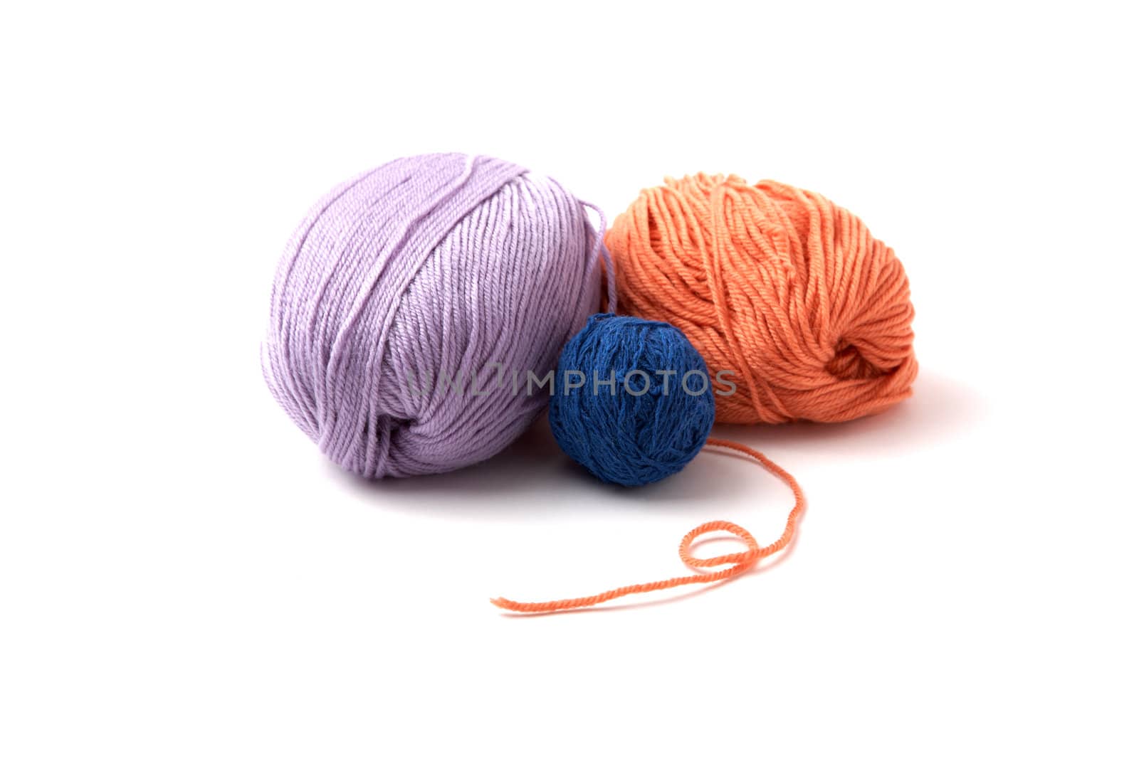 Balls of a multi-coloured yarn on  white background