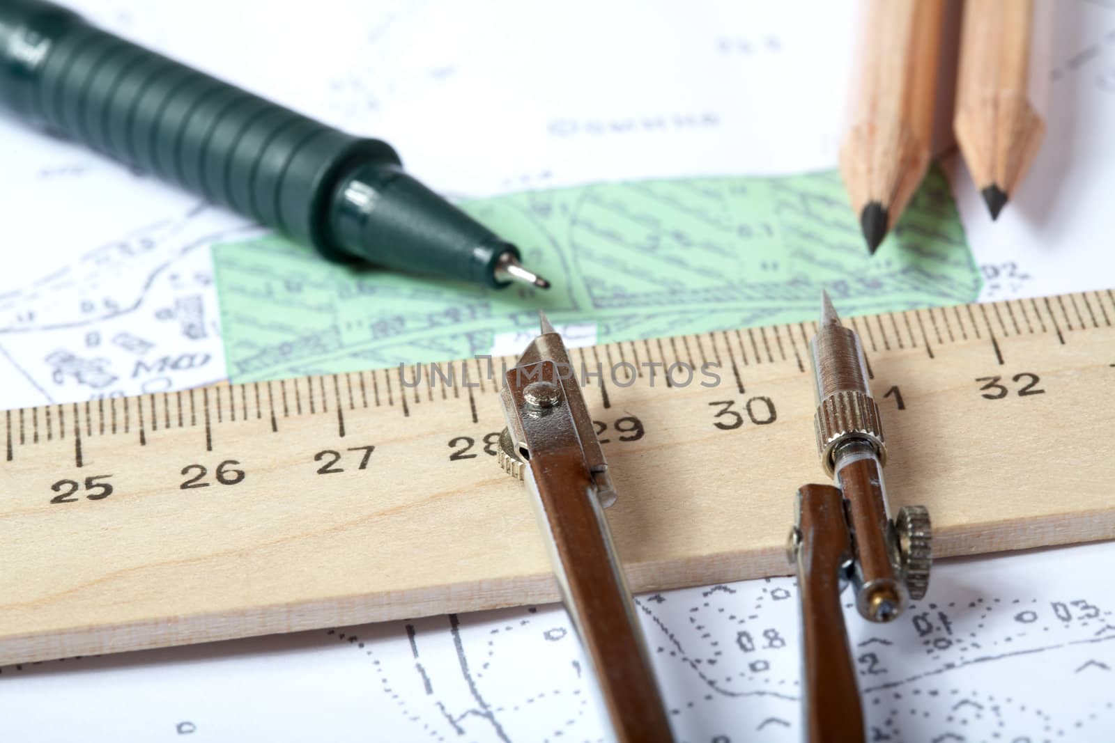 Topographic map of district with  measuring instrument,  ruler and a pencil