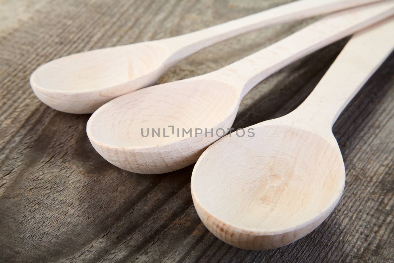 New wooden spoon on unplaned boards