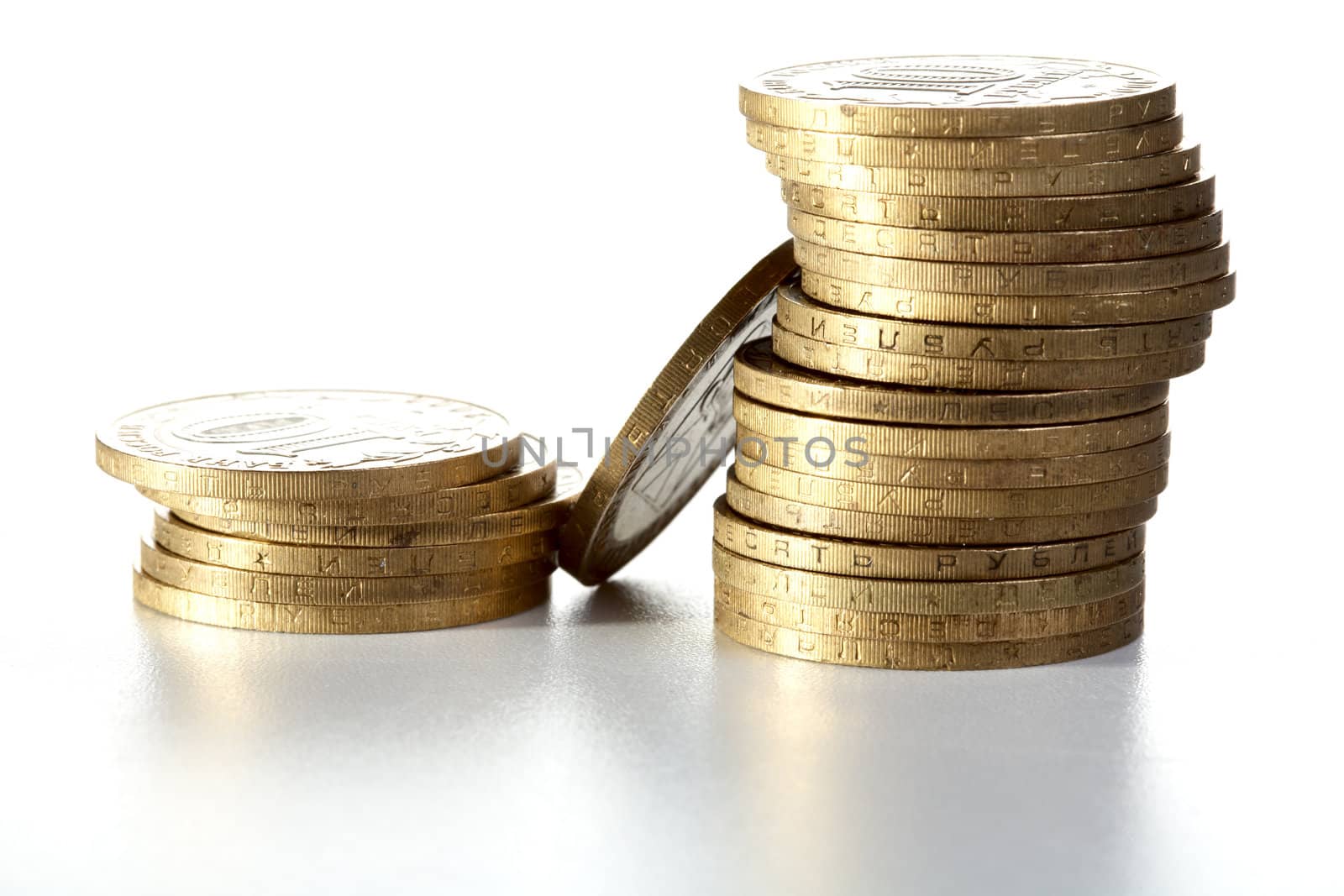 Pile of yellow metal coins on a textural background